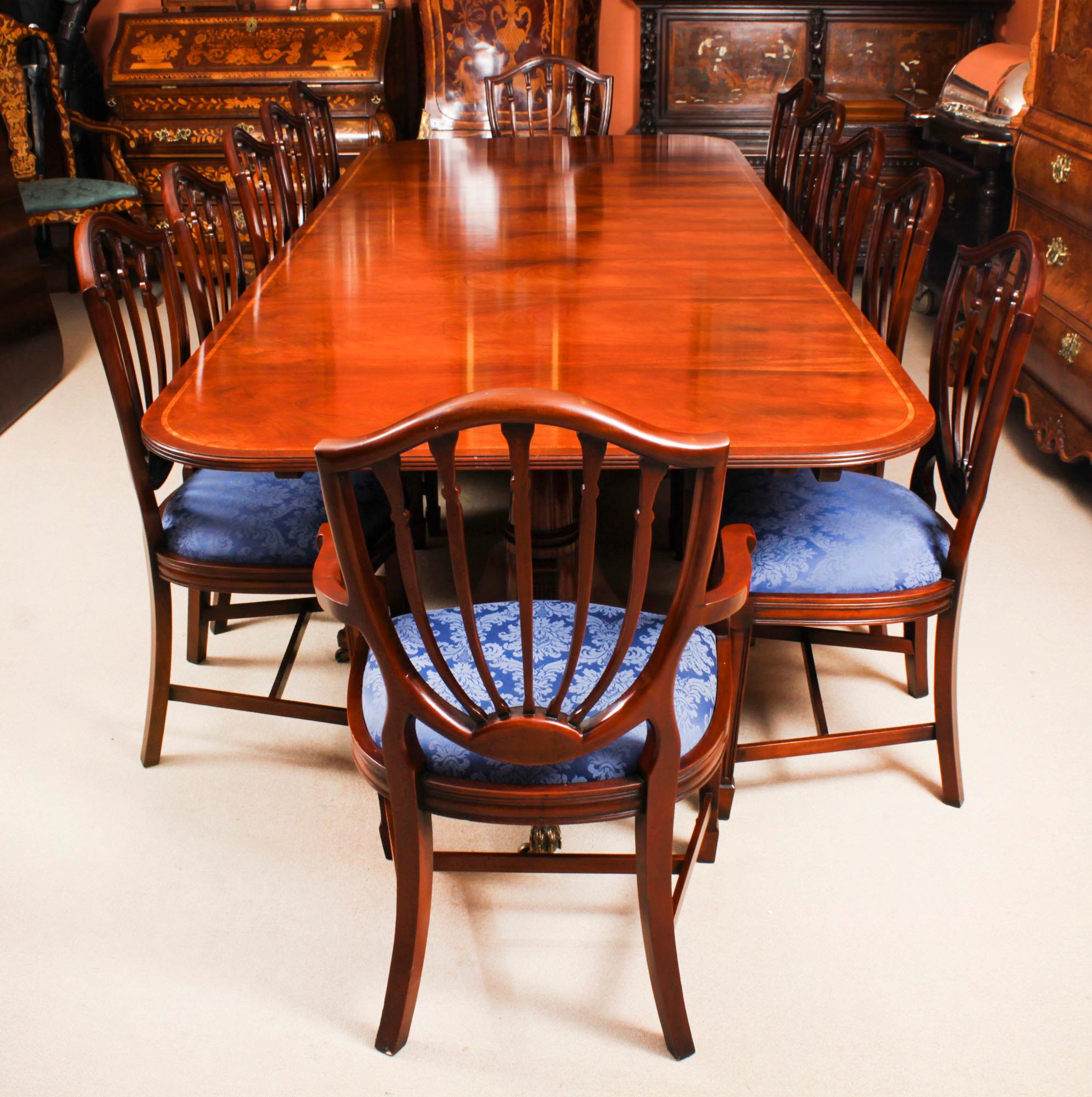 This is a superb large Vintage handmade double pedestal dining table in elegant George III style, by the master cabinetmakers Arthur Brett & Son, Norwich, crafted in flame mahogany with wood banding, numbered 761401 and dating from the mid 20th