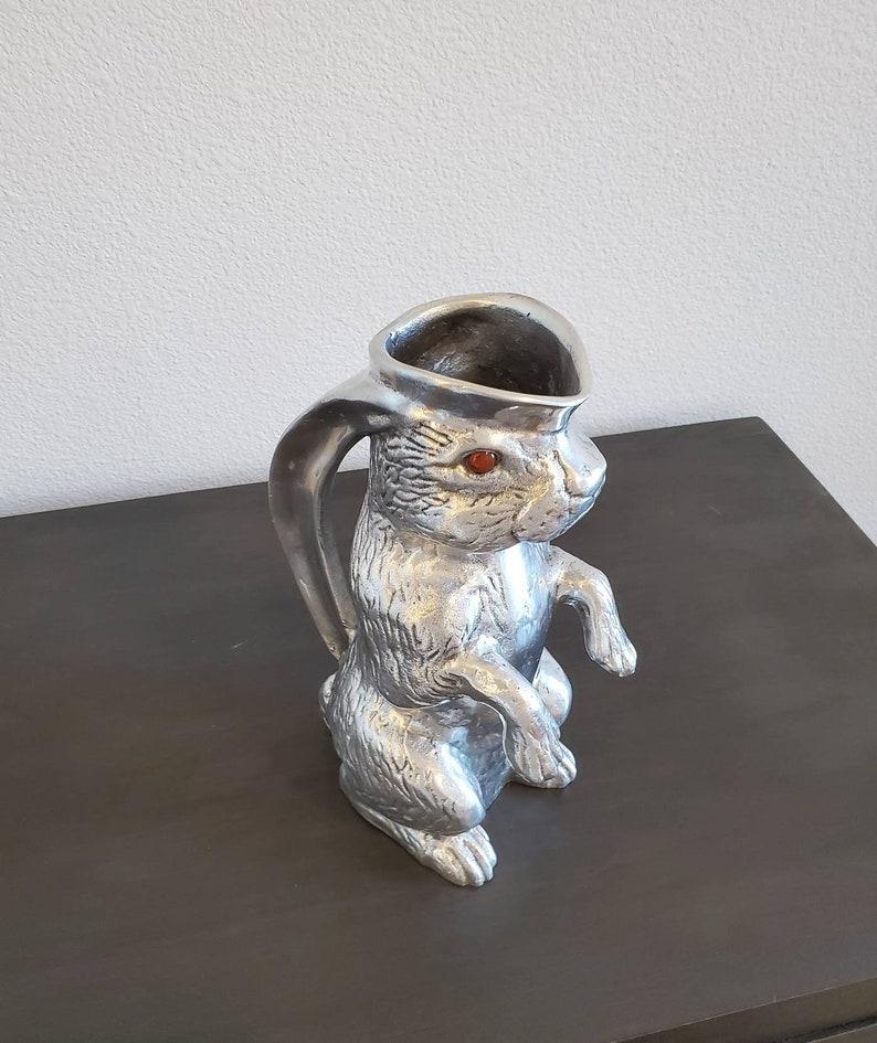 A whimsical and charming high quality American polished aluminum service pitcher by Arthur Court, San Francisco.

Born in the mid-20th century, this life-sized rabbit shaped pitcher was individually hand made & polished to a lustrous glow, lending