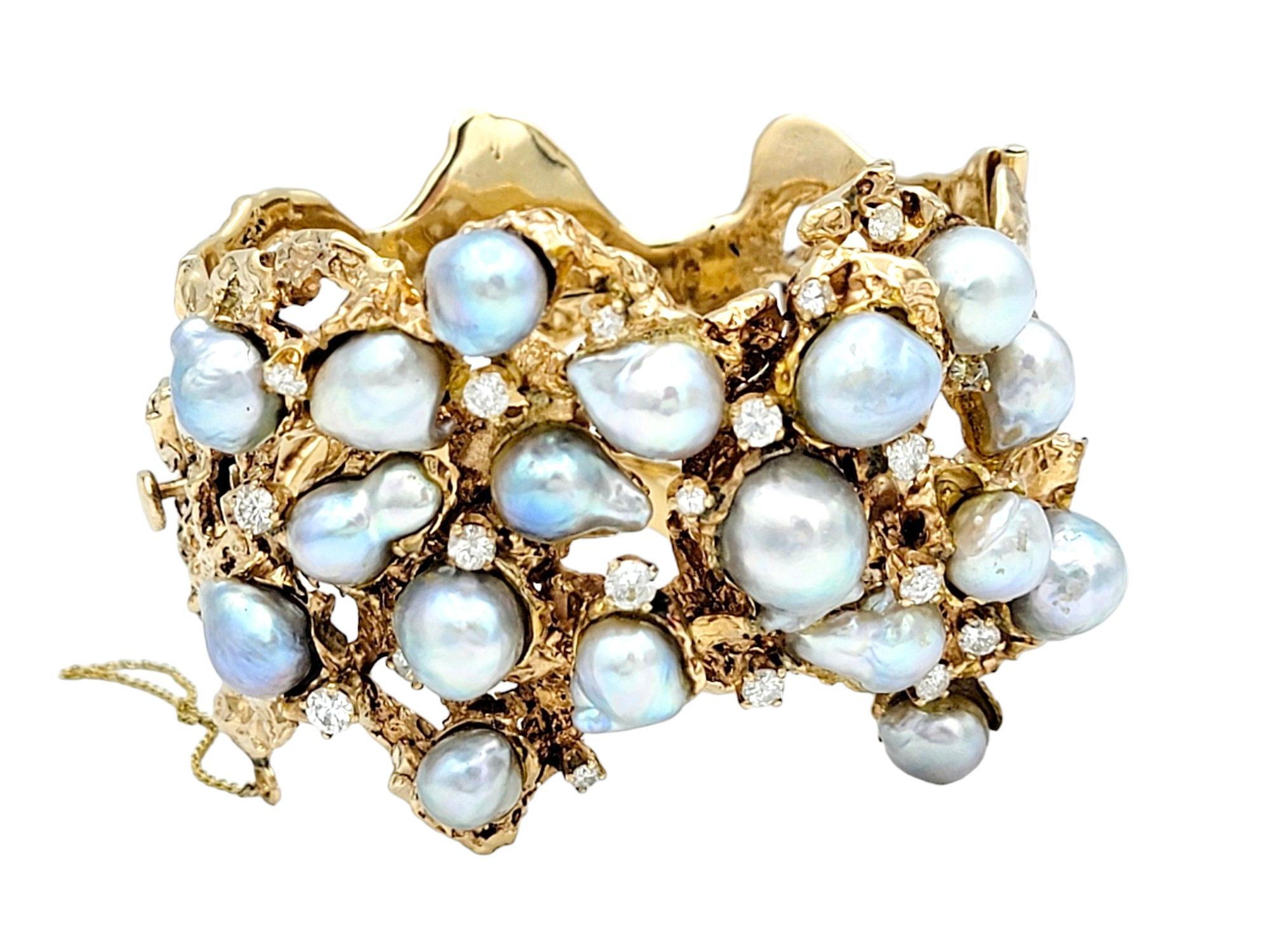 Elegance takes a sculptural form in this vintage Arthur King hinged bangle, a masterful creation in 14 karat yellow gold. The wide cuff features a series of lustrous cultured baroque pearls scattered in an asymmetrical dance across the expanse of