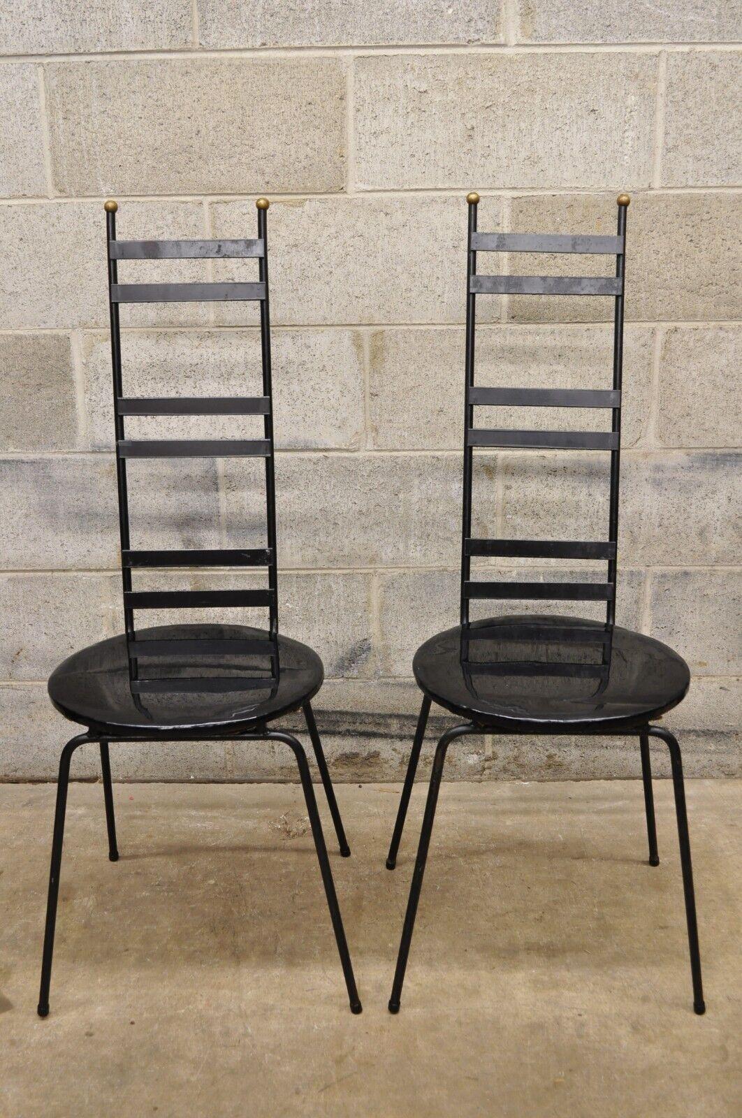 Vintage Arthur Umanoff Attributed Wrought Iron Ladder Back Chairs - a Pair. Item features round vinyl seats, brass ball form finials, narrow iron ladder backs, wrought iron construction, clean modernist lines, great style and form, attributed to