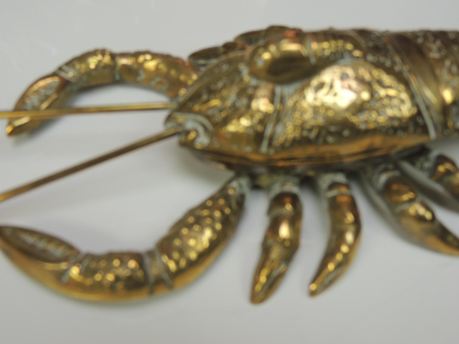 Vintage articulated brass lobster box.
Vintage detailed brass box of a lobster figurine, the front top opens to reveal the box.
India, 1970s.
Measures: 10
