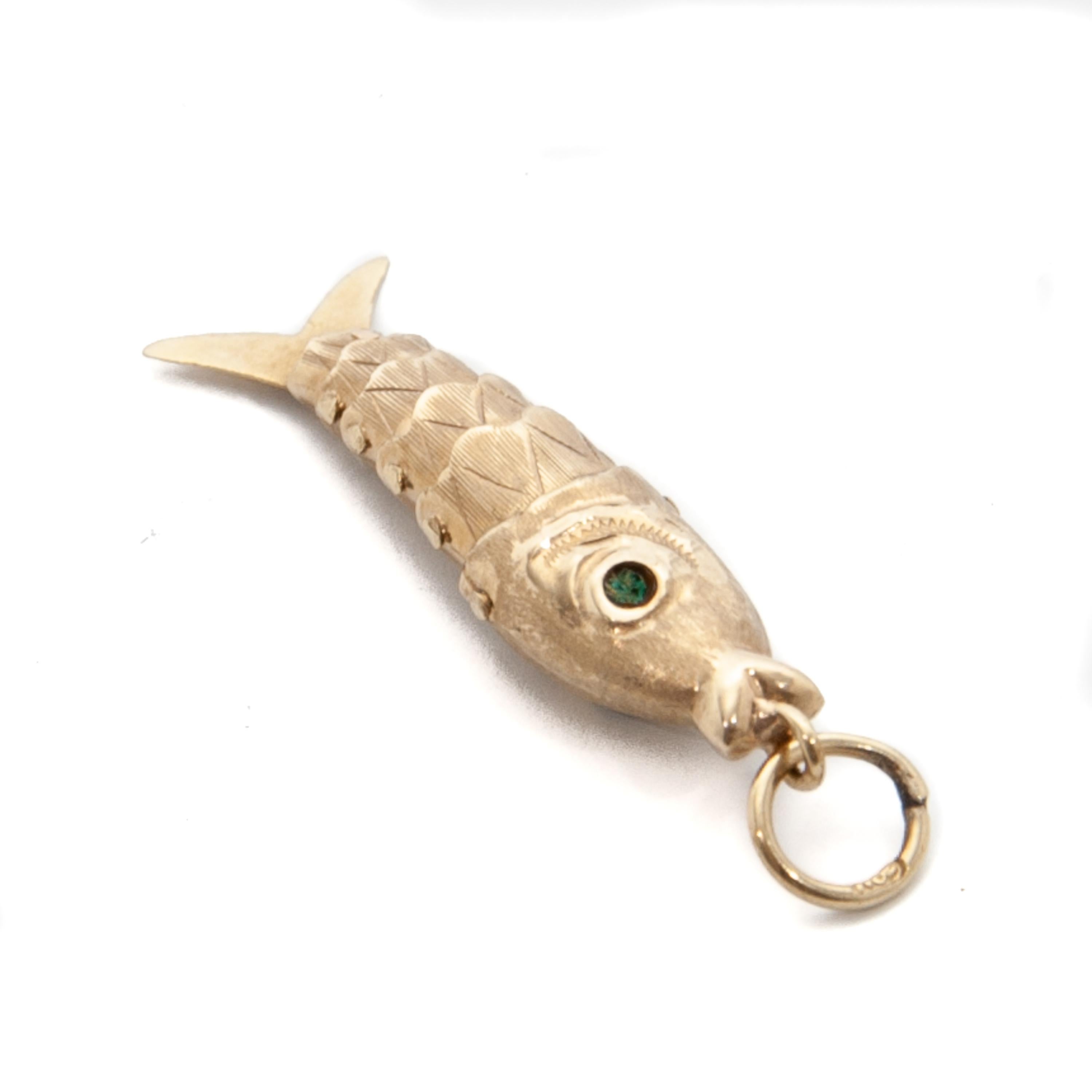 This vintage articulated gold fish charm is as lovely as it can be. This small wiggly fish is made with different sized gold sections, which inside are held together by pins that allow the fish to move back and forth. The section pieces are textured