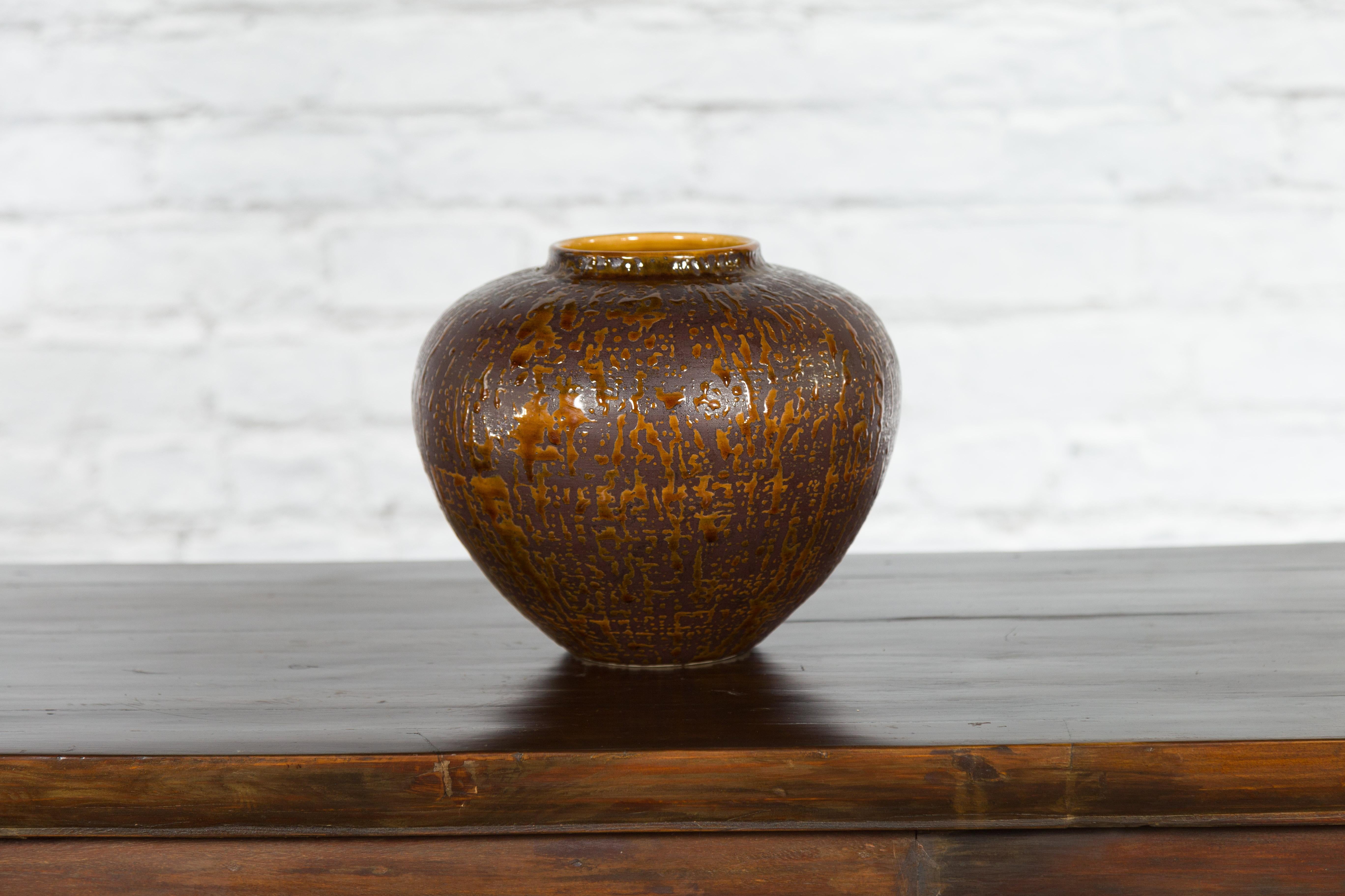 A large vintage Artisan ceramic jar from the Prem Collection, with dark brown glaze and caramel colored dripping. Hand-crafted during the last quarter of the 20th century, this artisan Prem Collection ceramic jar attracts our attention with its