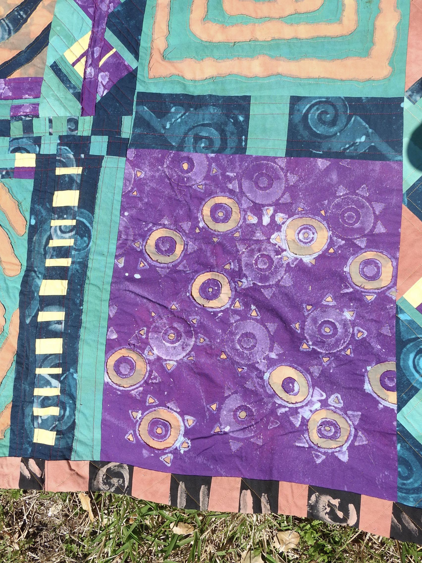 Vintage circa 1990's cotton textile artist made art quilt.  Abstract design with spirals, dyed cotton, machine pieced and quilted with a layered raw edge applique technique, low loft.
