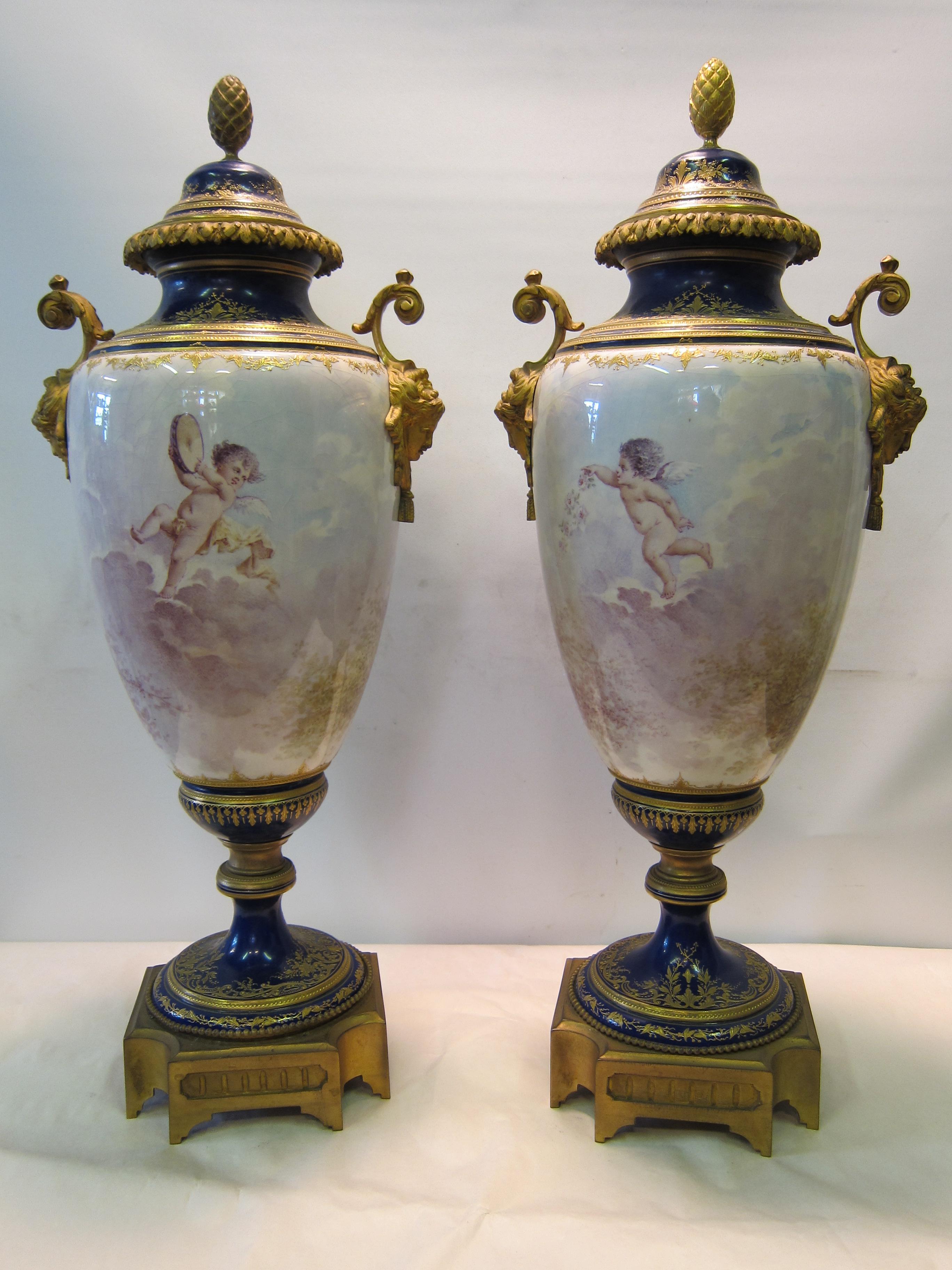 This fine pair of circa 1850s Sevres urns is signed by the artist Baston. The covered urns are beautifully hand painted & depict romantic scenes of courtship. Each urn features two young adults, costumed in period clothing, closely guarded by