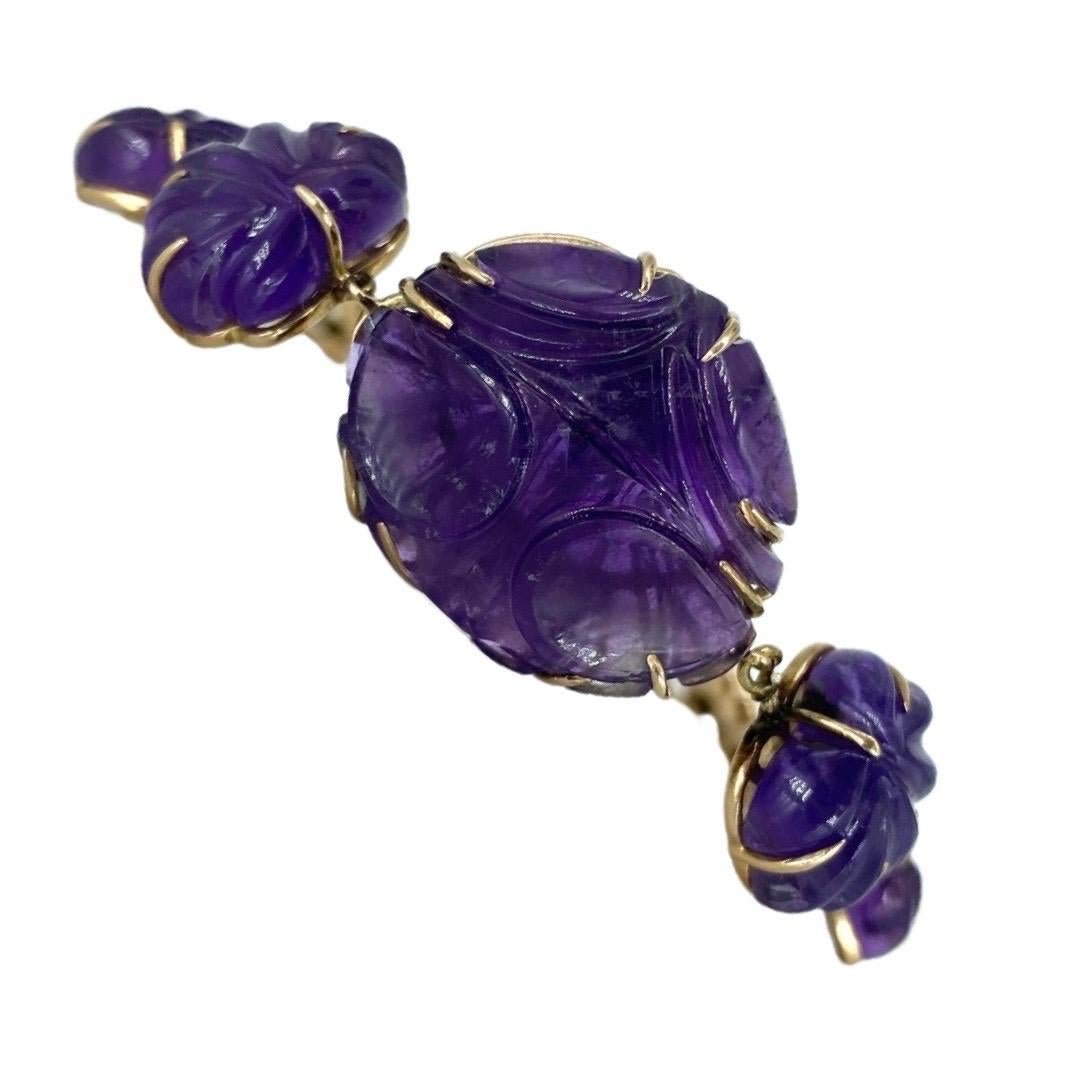 Vintage Artistic Art Carved Amethyst Gemstone Bracelet 14k Gold. Very detailed work of art by this designer. The main amethyst measures 21mm X 24mm X 7mm and weights a total of 27.9 grams. The bracelet is 7 inches in length and is made in 14k gold.