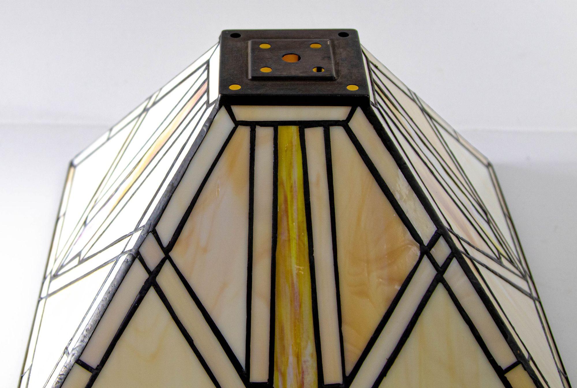 Vintage Arts & Crafts Mission Frank Lloyd Wright style stained glass lamp shade.
Large square shape vintage hand crafted table lamp shade with intricate designed with mosaic of cut glass each accentuating one another in soft hues of colors in beige