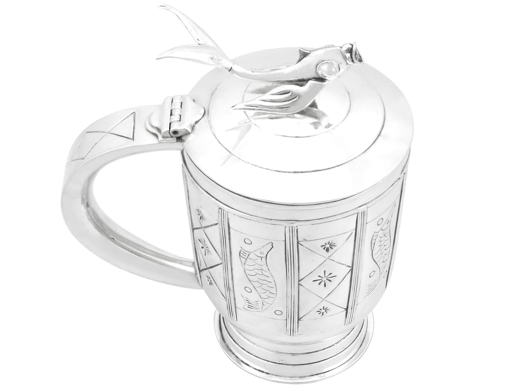 An exceptional, fine and impressive, unique vintage Arts and Crafts English sterling silver tankard; an addition to our silver tankard collection.

This exceptional vintage sterling silver tankard has a tapering cylindrical form onto a stepped foot,