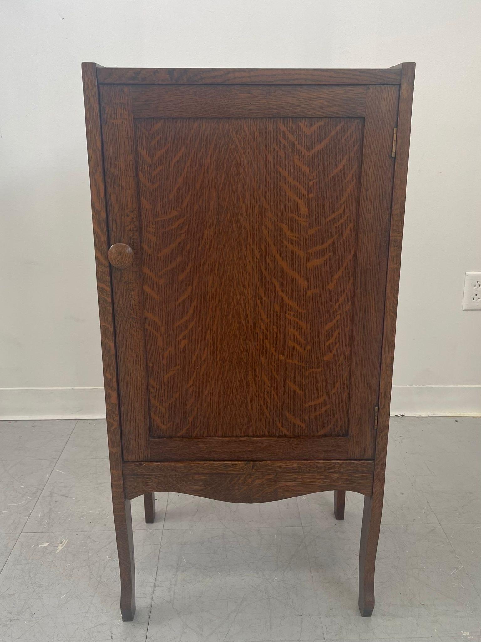 Possibly Tiger Oak, based on Appearance. Cabinet has Several Shelves inside.Wooden Handles. Vintage Condition Consistent with Age as Pictured.

Dimensions. 27 1/2 W ; 14 D ; 37 H