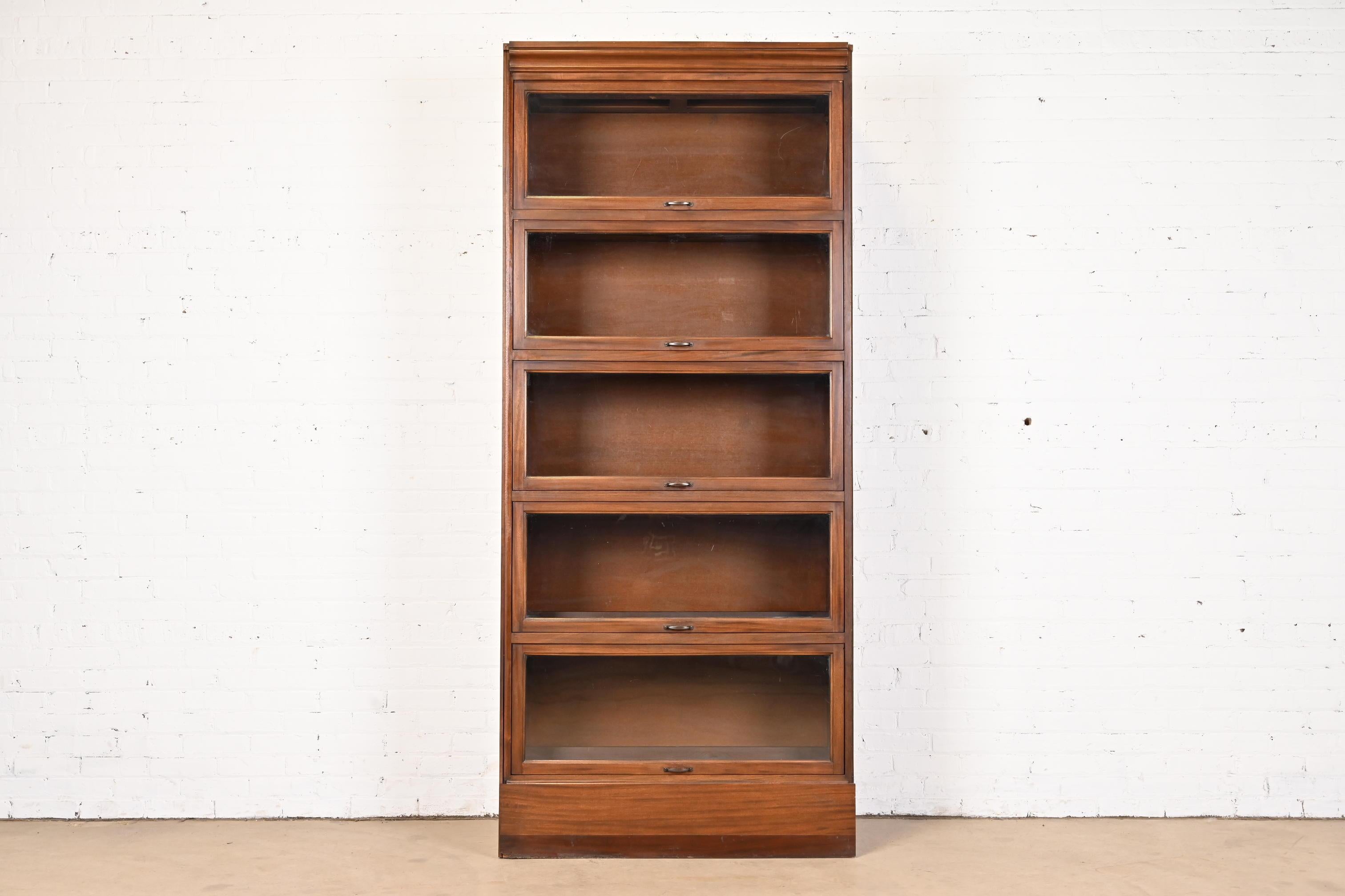 A gorgeous vintage Arts & Crafts large five-stack barrister bookcase

In the manner of Globe Wernicke

USA, Mid-20th Century

Mahogany, with glass front doors and brass hardware.

Measures: 38.88