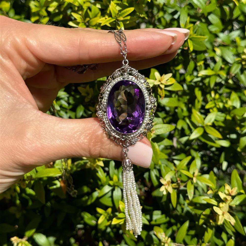 Simply Beautiful! Arts & Crafts Amethyst and Seed Pearl Tassel Gold Drop Vintage Necklace. Centering a 45 Carat Oval Amethyst surrounded by Seed Pearls and suspending a Multi Strand Seed Pearl Tassel. Hand crafted Gold mounting. Approx. dimensions