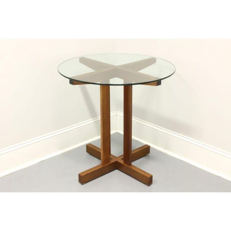 An Arts & Crafts style glass top accent table, unbranded. Solid wood base with a light tone in an 