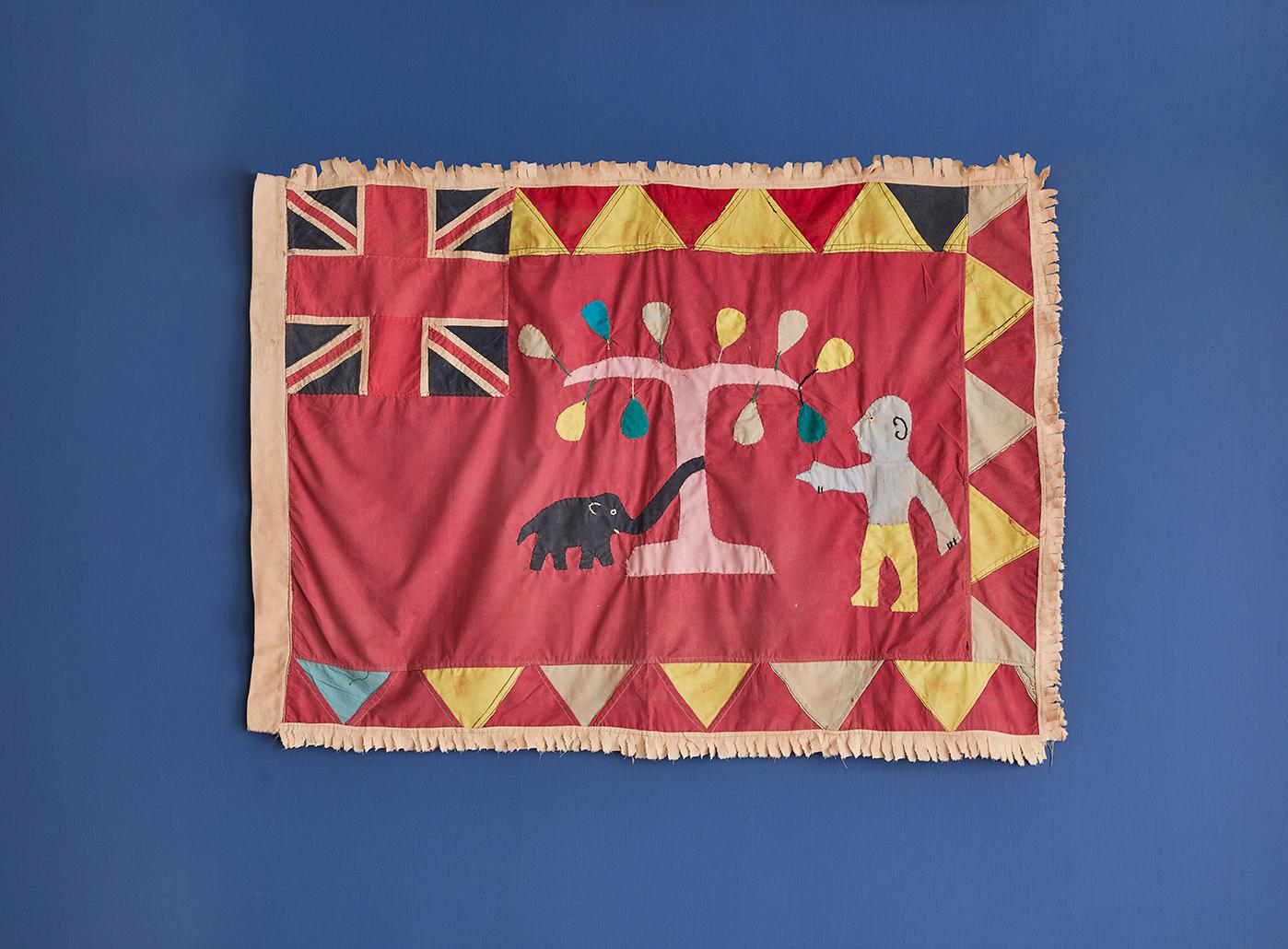 Vintage Asafo flag in cotton appliqué patterns, dating from the late 1940s, pre-independence in 1957. This example represents 'the Tree of Wisdom'. The Elephant commonly represents wisdom and longevity in many African cultures.

The colourful