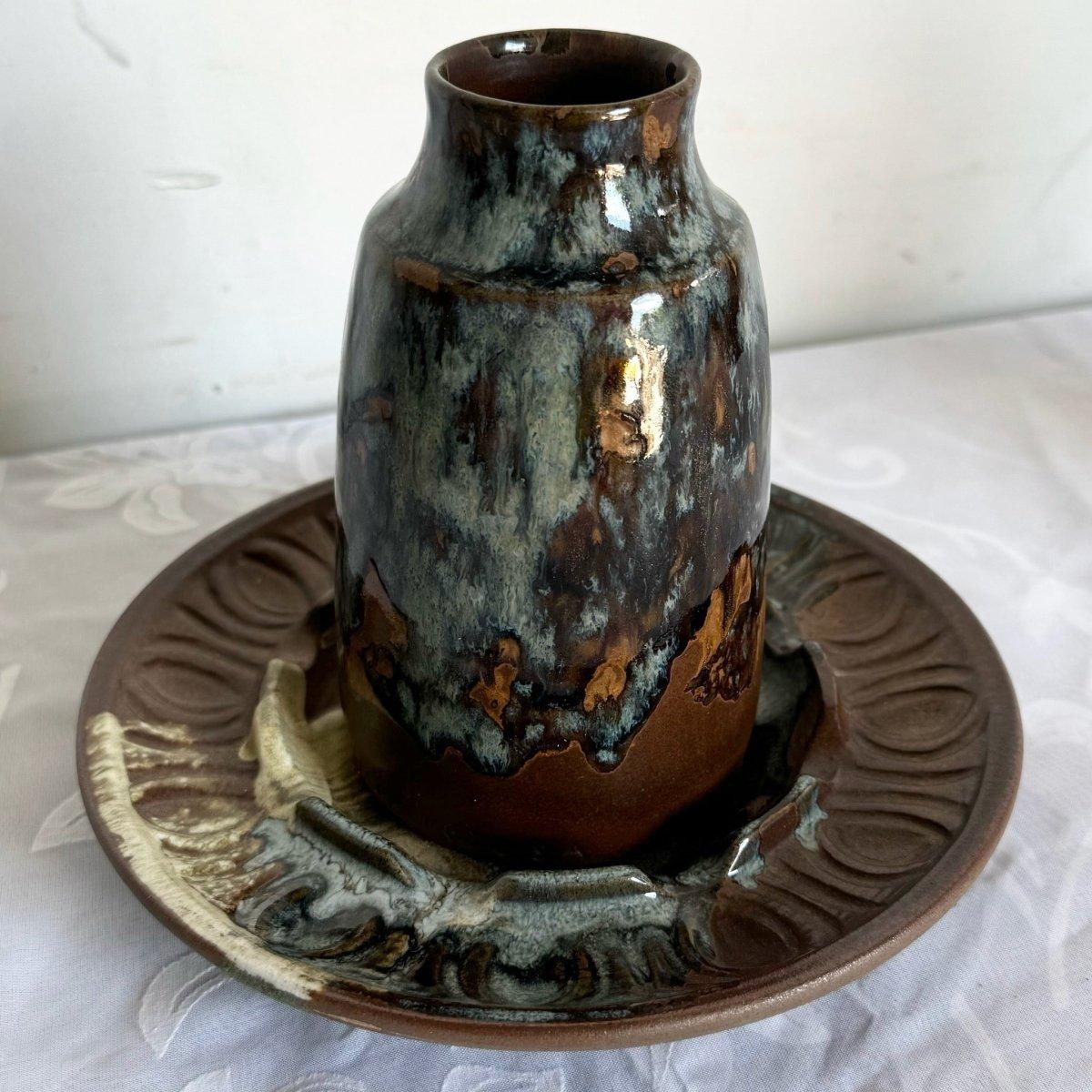 This vintage Pottery Craft ashtray and vase set offers a unique blend of rustic charm and functionality. Crafted with earthy tones and a handmade feel, these two pieces are perfect for adding a touch of vintage flair to your home decor or