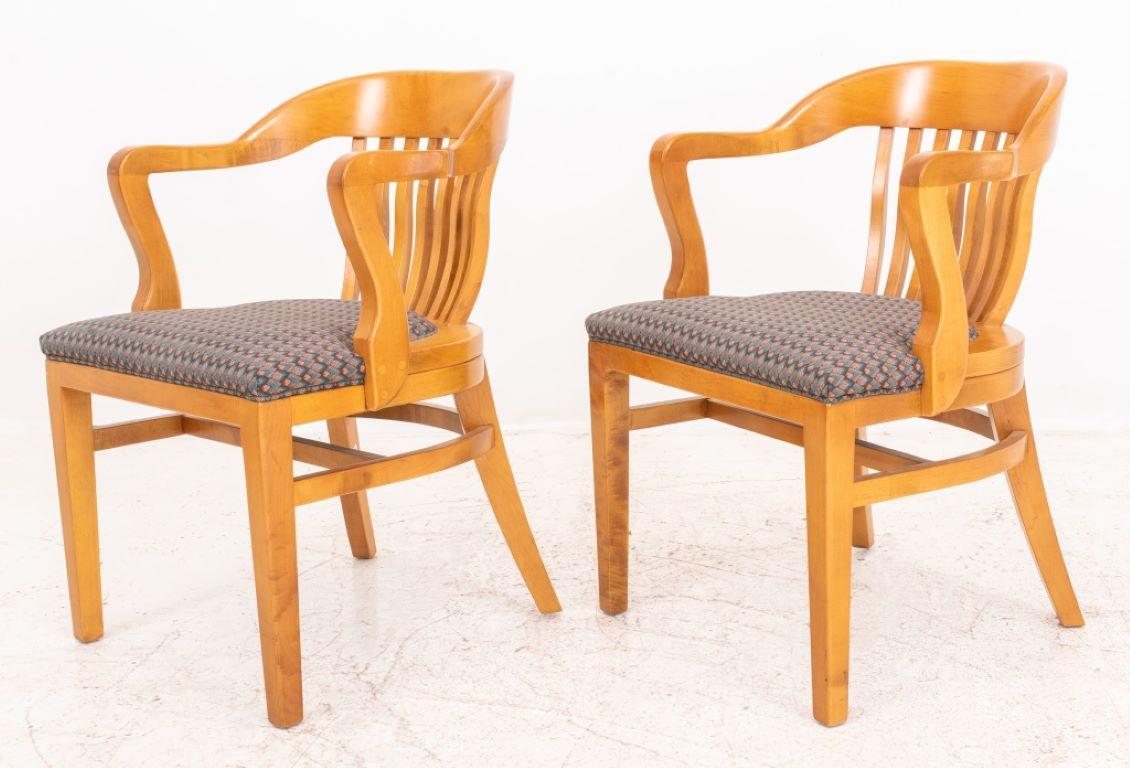 Vintage Ash wood Banker's chairs, a pair, with curving crest rail and arms above eight back splats, with upholstered seats above square tapering legs to front and sabre legs to back.

Dealer: S138XX