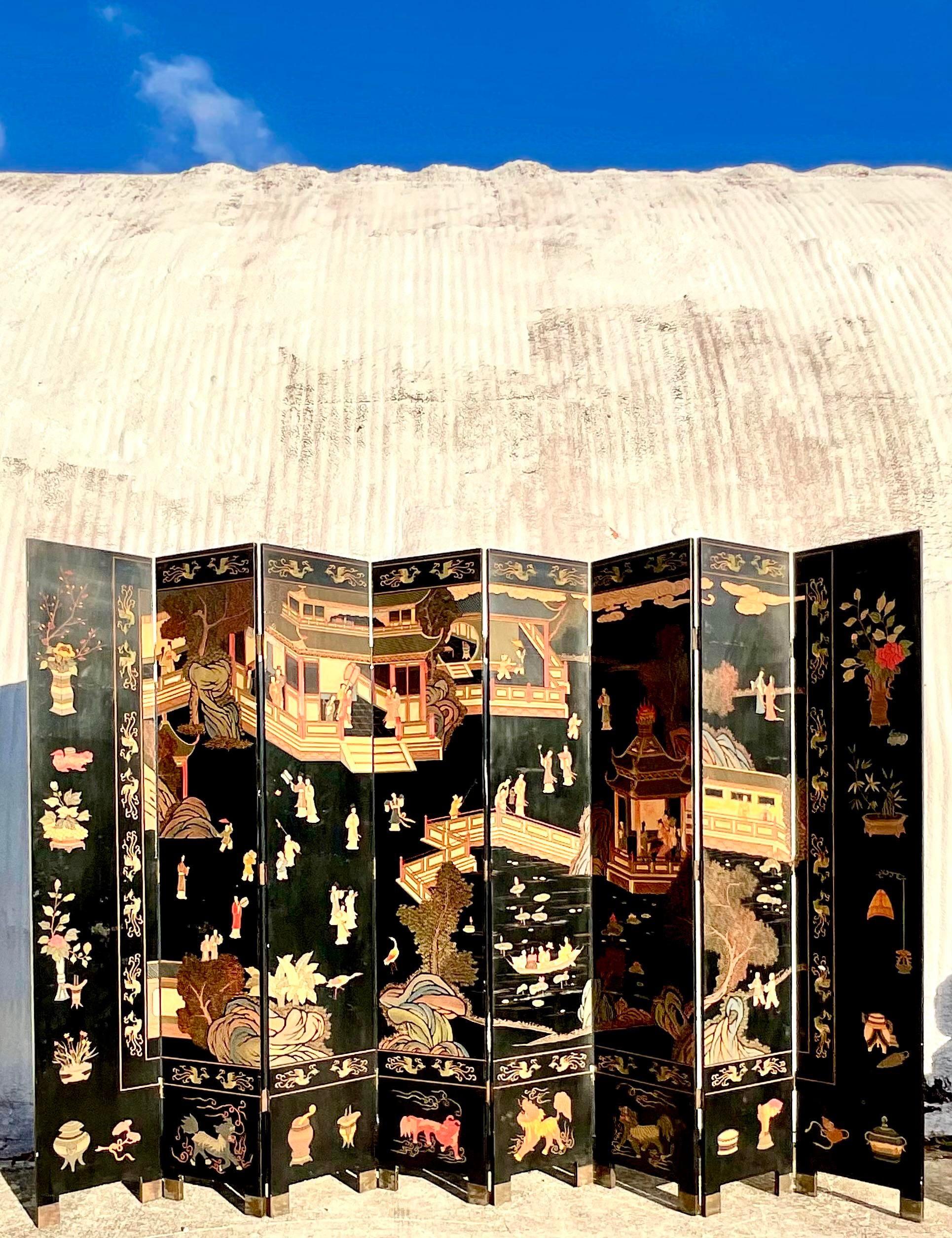 Incredible vintage Asian folding screen. An iconic Coromandel design with floating Asian figures and scenes of a small town. Truly striking. Acquired from a Palm Beach estate.