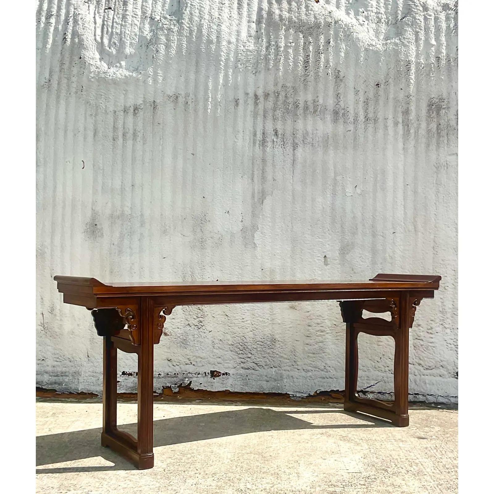 An outstanding vintage Asian console table. A chic altar design with pagoda sides. Made by the iconic Baker Furniture group. Acquired from a Palm Beach estate.