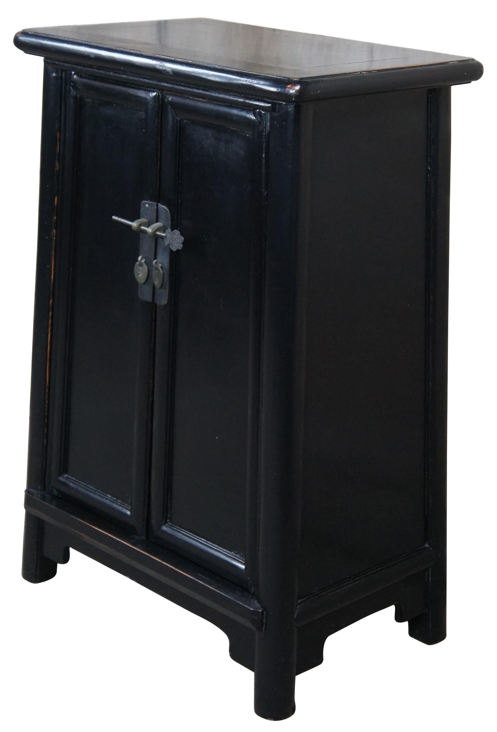 Late 20th Century black lacquer elm altar storage cabinet, bedside table or console.  Traditional ming style form with 2 doors that open to a divided interior with two drawers.   Great for use in a hallway, entry, bedroom or bathroom.  