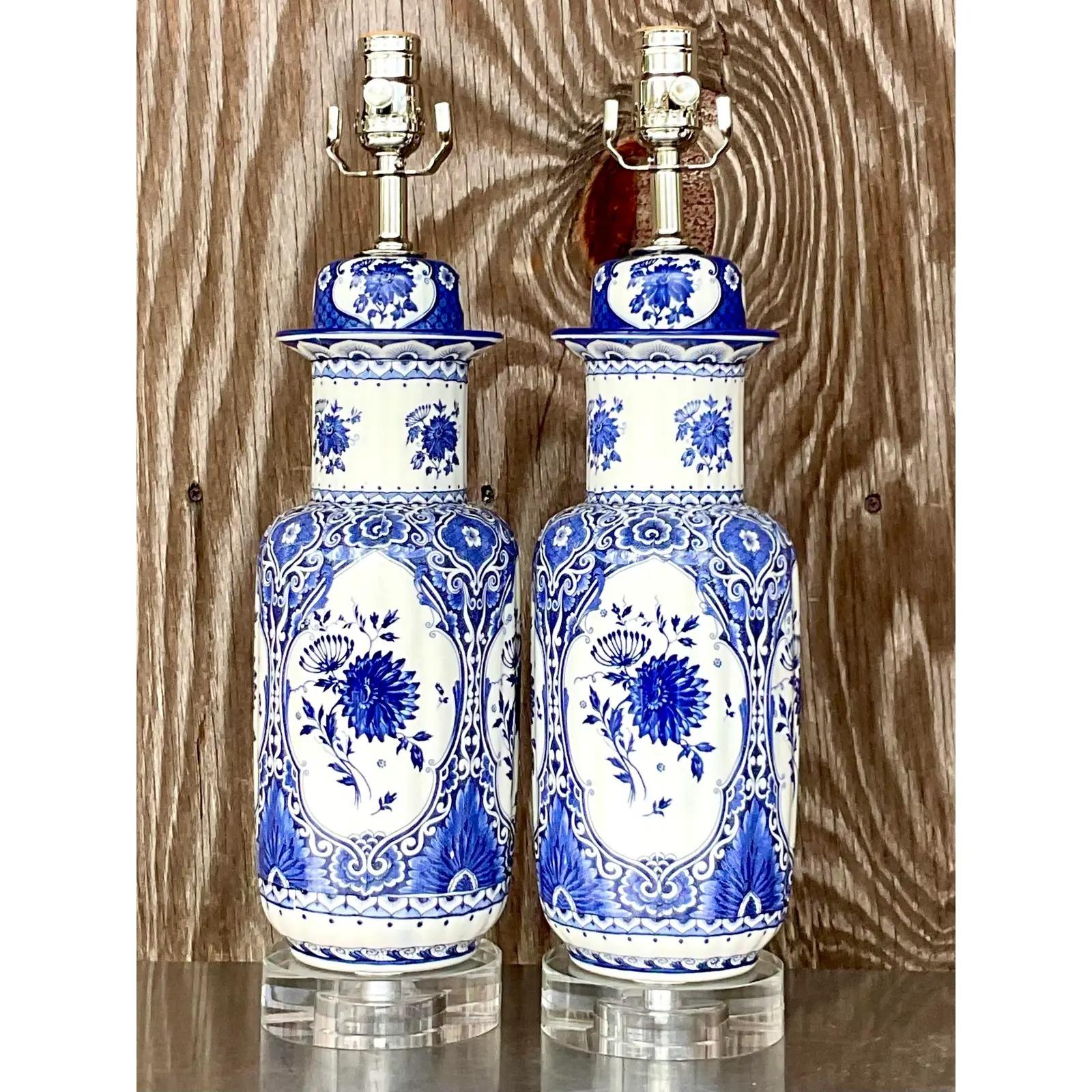 A fabulous pair of vintage Asian table lamps. A beautiful tall jar with classic blue and huge designs. Fully restored with all new hardware and wiring. Acquired from a Palm Beach estate.