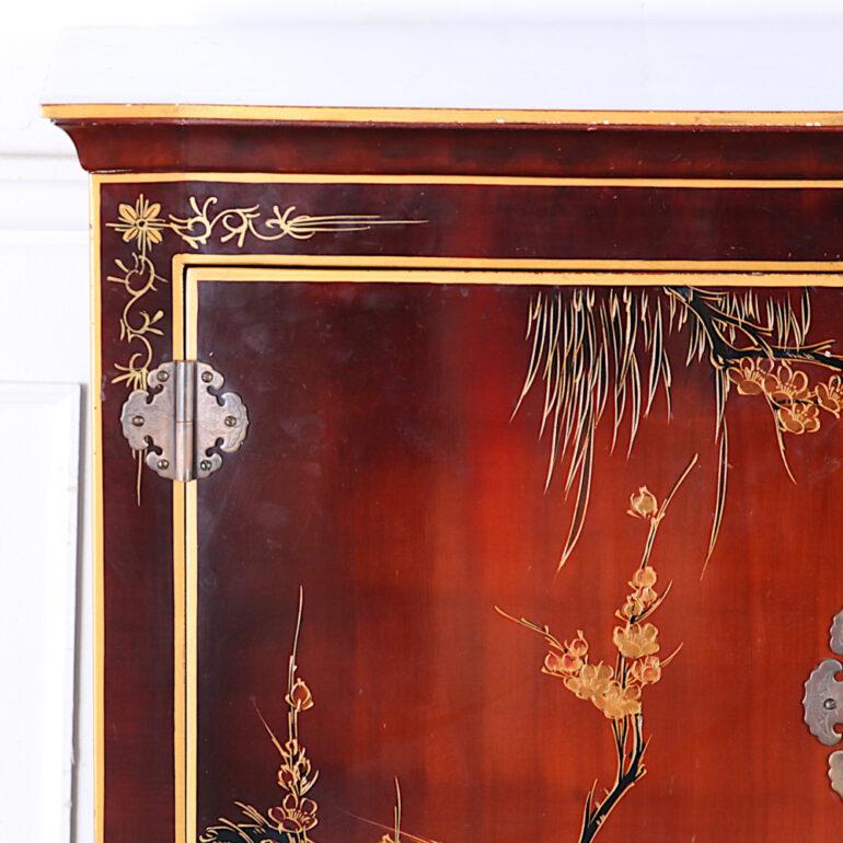 Vintage Asian lacquered and gilt cabinet featuring hand-painted trees and birds.