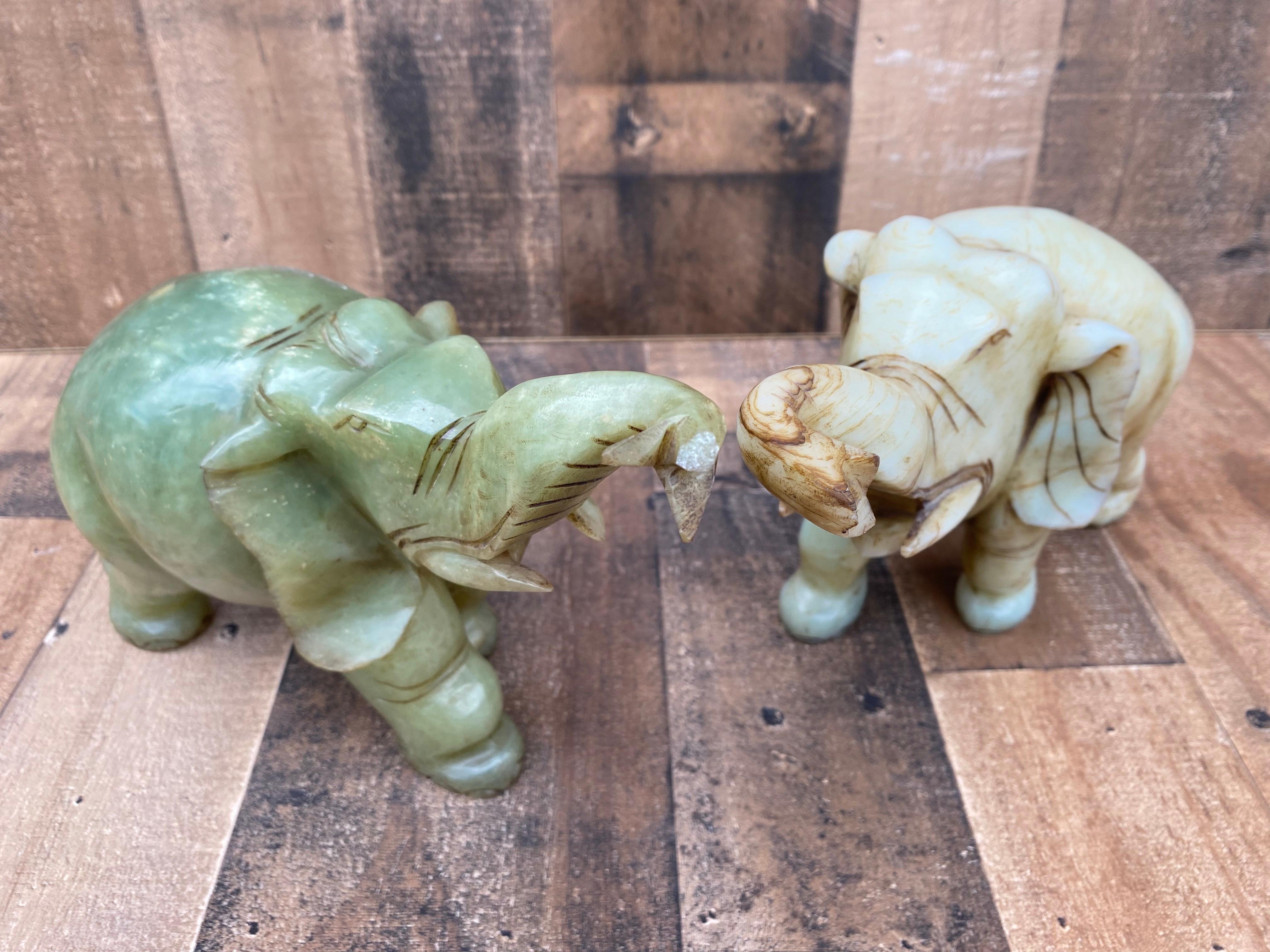 Vintage Asian Carved Jade Style Stone Elephants Figurines - Set of 2

While both these elephants are carved from jade, one elephant from this set is beige and the other is green. They would beautifully decorate your mantlepiece, coffee table, or
