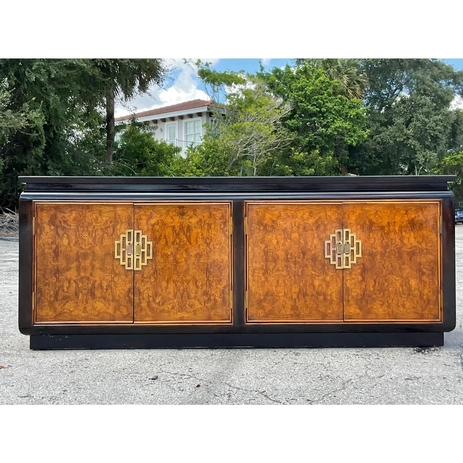 Fantastic vintage Asian Credenza. Made by the iconic Century Furniture group. Beautiful Burl wood cabinet with black lacquer trim. Heavy brass medallion hardware. Acquired from a Palm Beach estate.