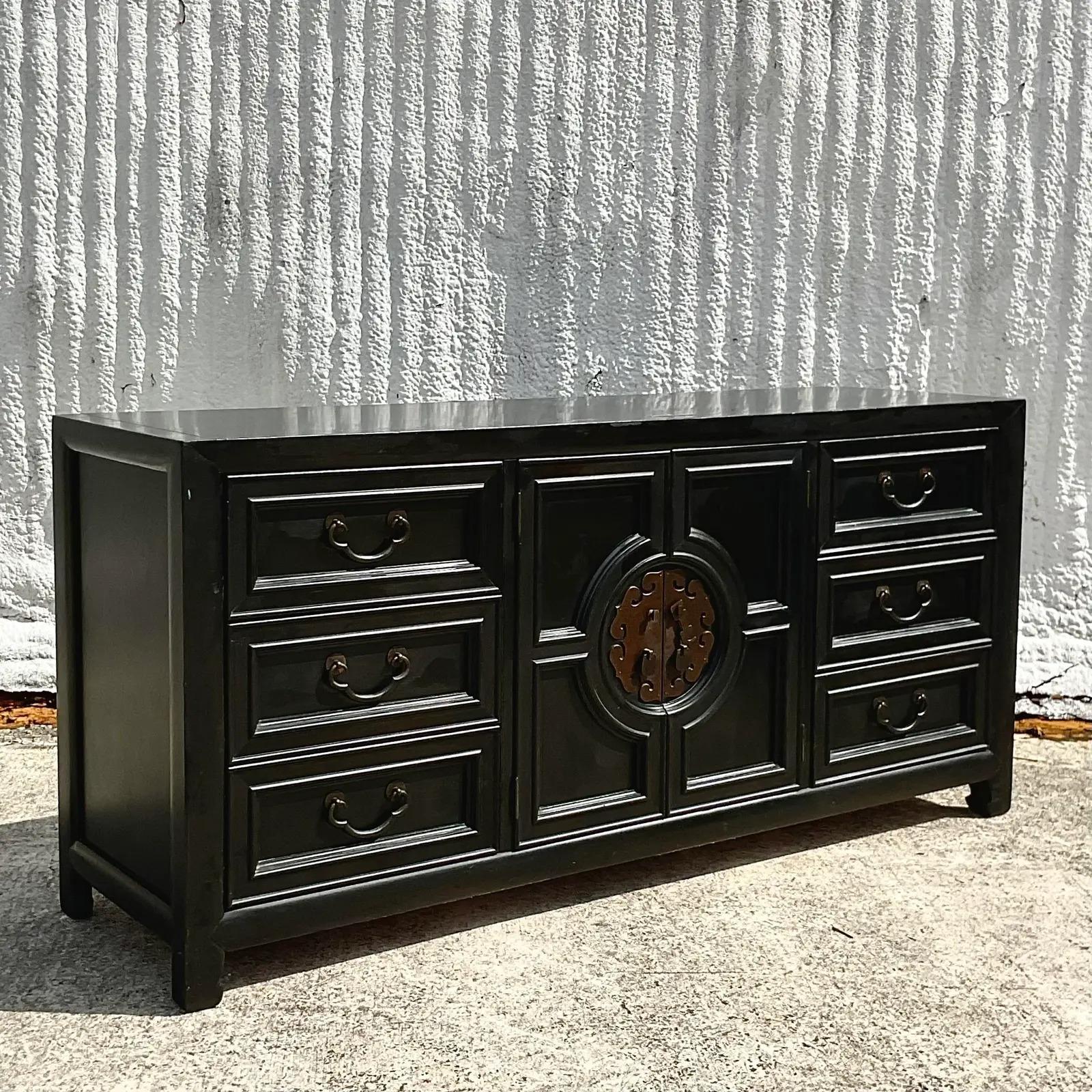 A fantastic vintage Asian Ming credenza. Made by the iconic Century Furniture group. Signed on the inside drawer. Beautiful matte black finish with heavy medallion hardware. Acquired from a Palm Beach estate. 