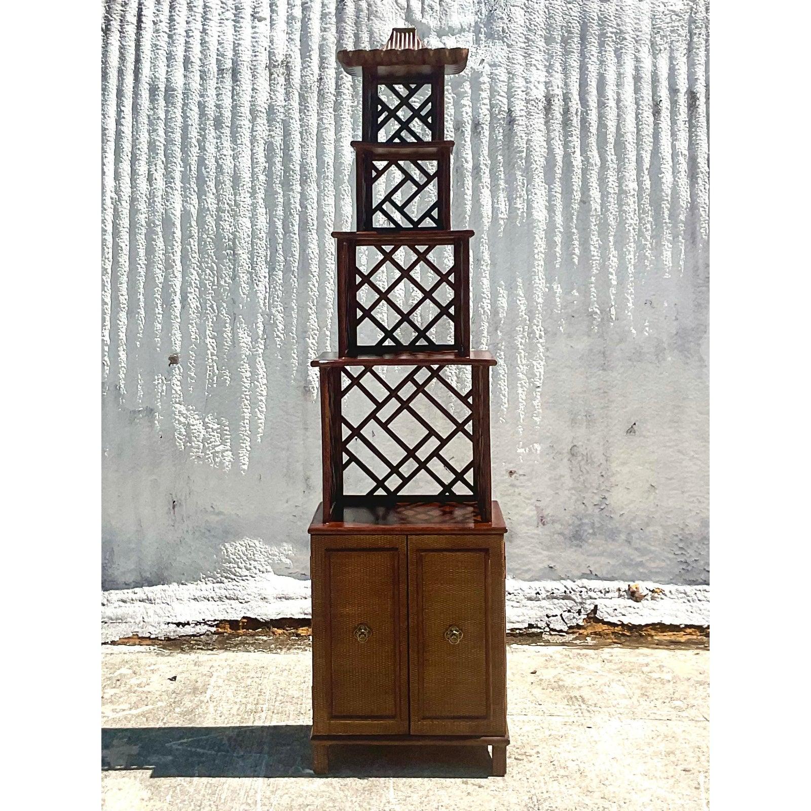 Fantastic vintage Asian Pagoda Etagere. Iconic Chinese Chippendale design. Woven rattan base with brass hardware. Acquired from a Palm Beach estate.