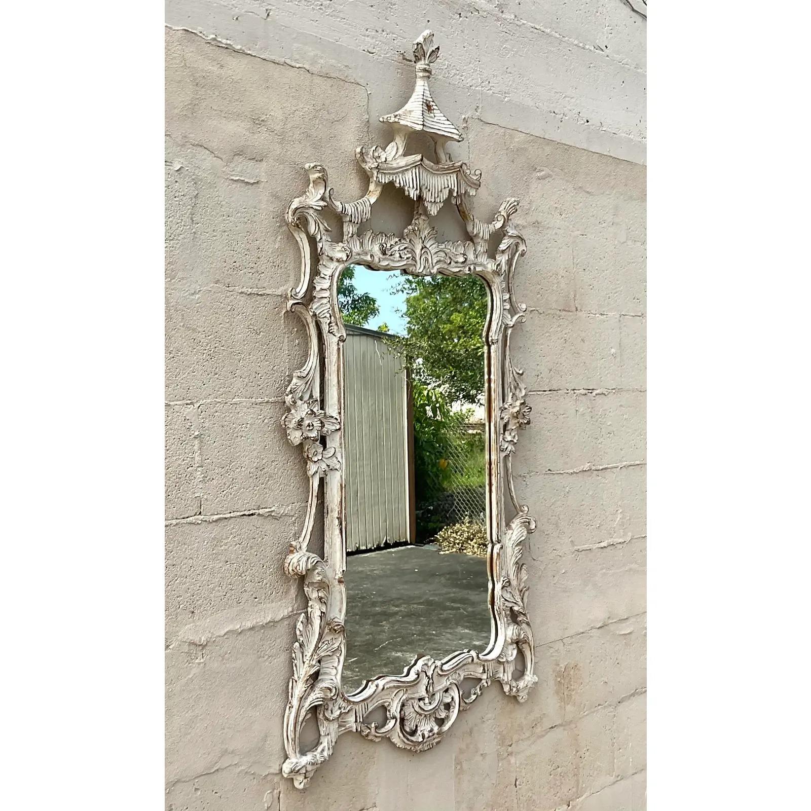 Fantastic vintage hand carved Chinoiserie mirror. A beautiful carved pagoda mirror with a charming little pagoda roof top. A chic cerused finish adds to the glamour. Acquired from a Palm Beach estate.
