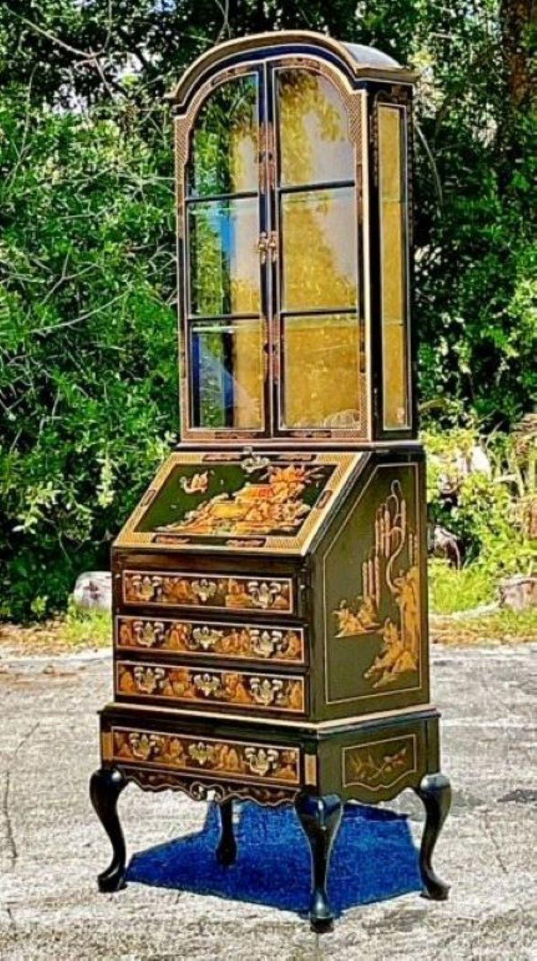 The Vintage Asian Chinoiserie Secretary Desk blends American style with Eastern elegance, featuring intricate Chinoiserie detailing and exquisite craftsmanship. This versatile desk adds a touch of vintage charm and sophisticated allure to any home