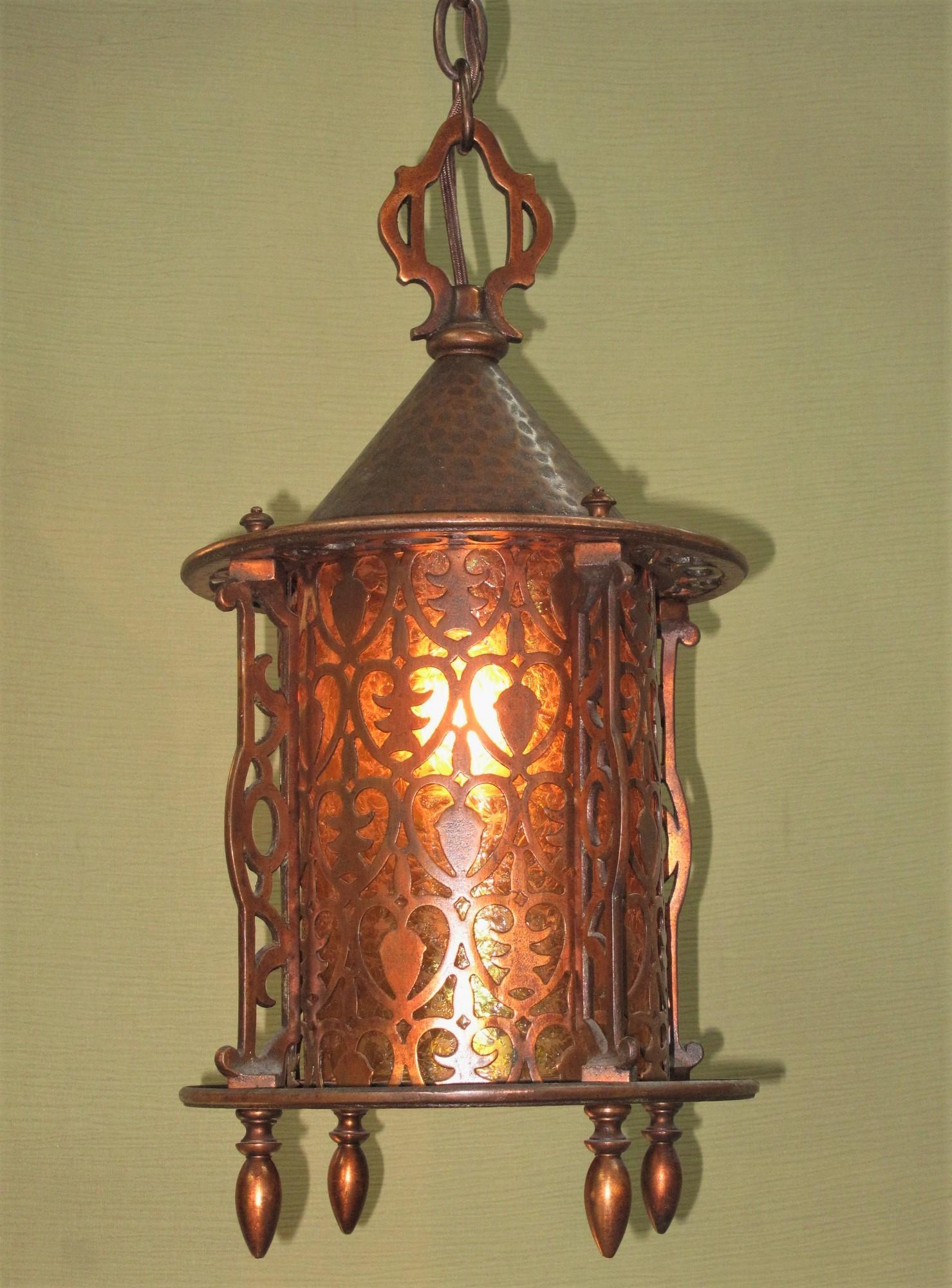 Beautifully detailed copper clad porch light with original finish, patina, oval chain, and glass shade. Rewired to UL standards including code required ground wire. Craftsman style influence with hammered shade cap and hearts cutout in the shade