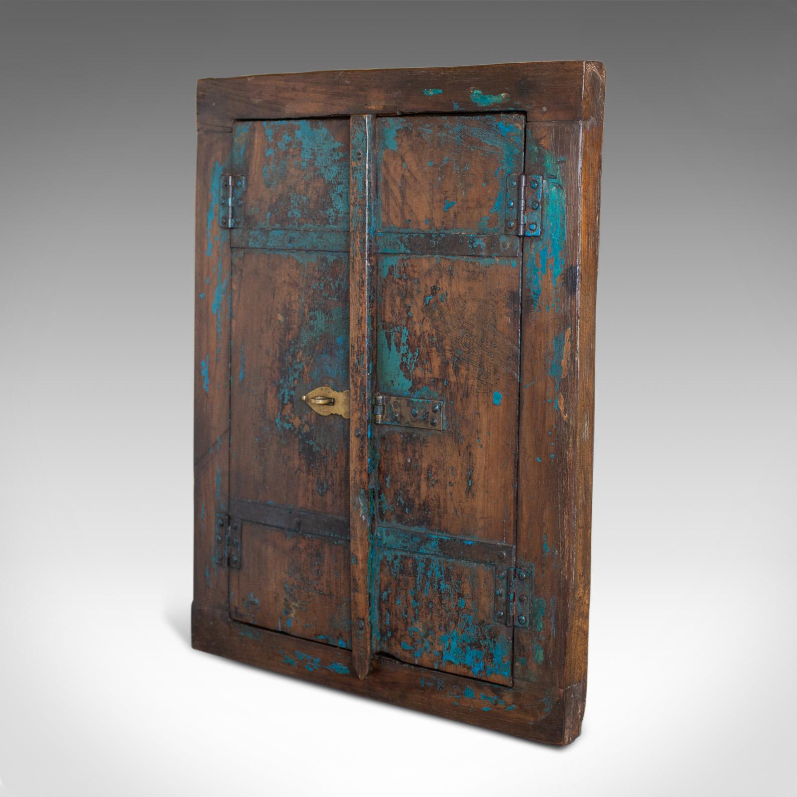 This is a vintage Asian cupboard mirror. A rustic wall cabinet with a mirror inside. Dating to the mid-late 20th century.

Charming distressed turquoise paint finish
Cabinet closing with shaped, brass hasp and fastener
Doors open easily to