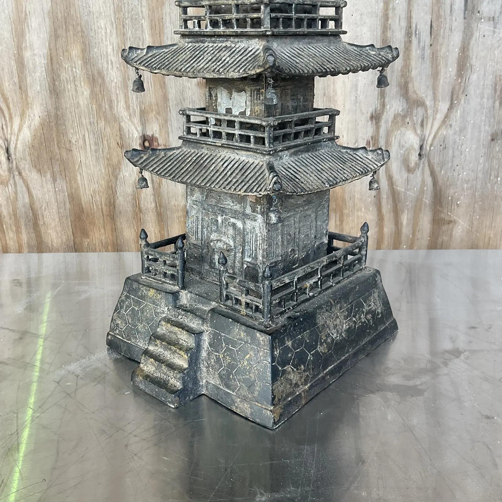 Incredible vintage Asian wrought iron pagoda. Beautiful elegant design with a mottled distressed finish. Little bells at the end of each roof leak. Acquired from a Palm Beach estate.
