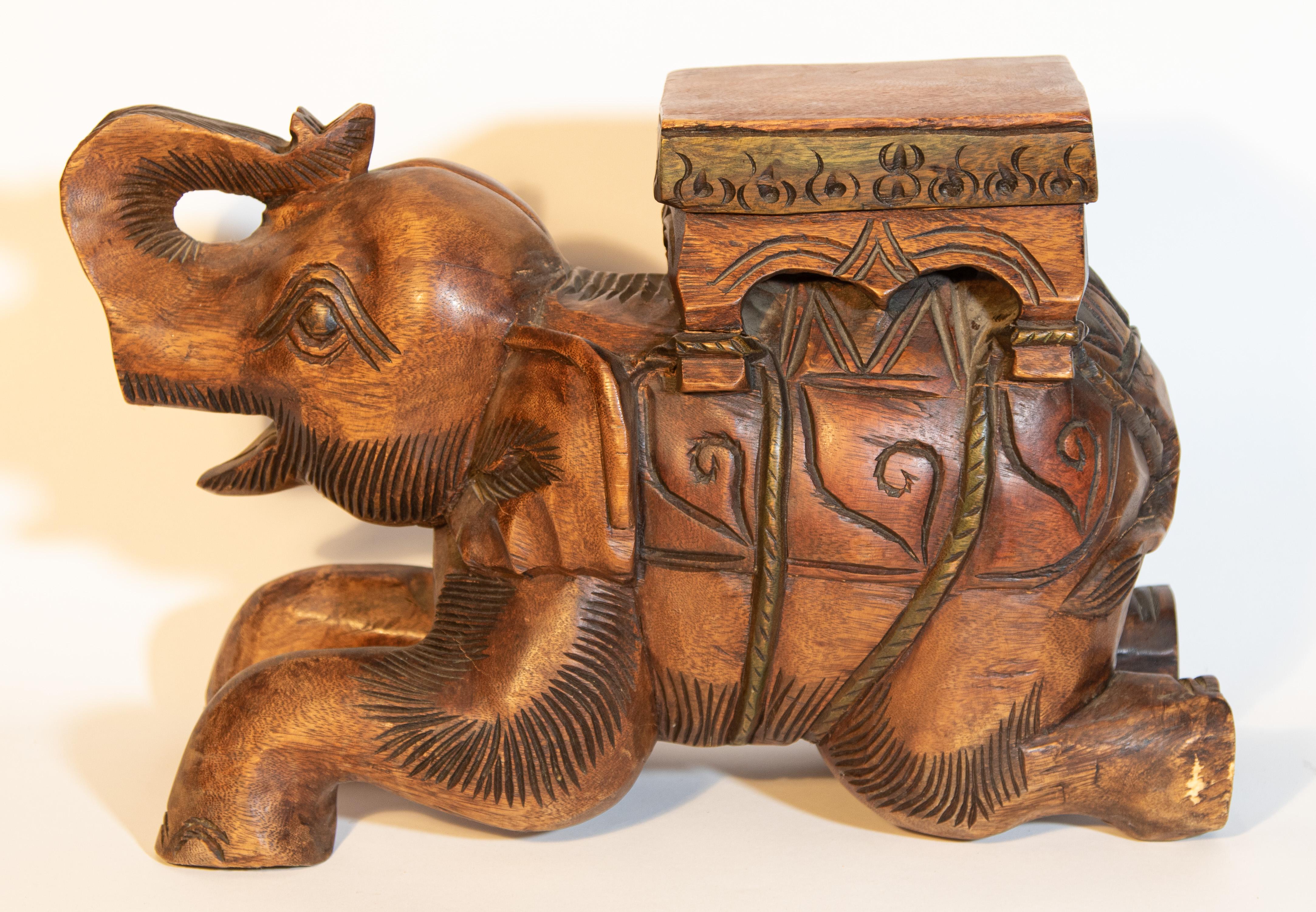 Hand-carved vintage wooden South Asian elephant stool, or side table, very nice hand-carved on one piece of wood.
Could be used as side table, with a piece of glass or plant stand.
Artfully hand-carved wood drink side table in elephant