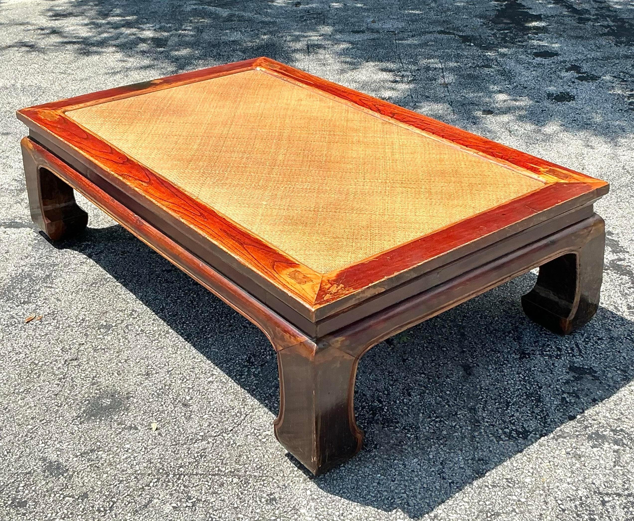 Infuse your space with the serene elegance of this Vintage Asian Elm and Seagrass Ming Coffee Table. Crafted from rich elm wood and featuring a woven seagrass top, this piece reflects the timeless beauty of traditional Ming dynasty design. Its clean