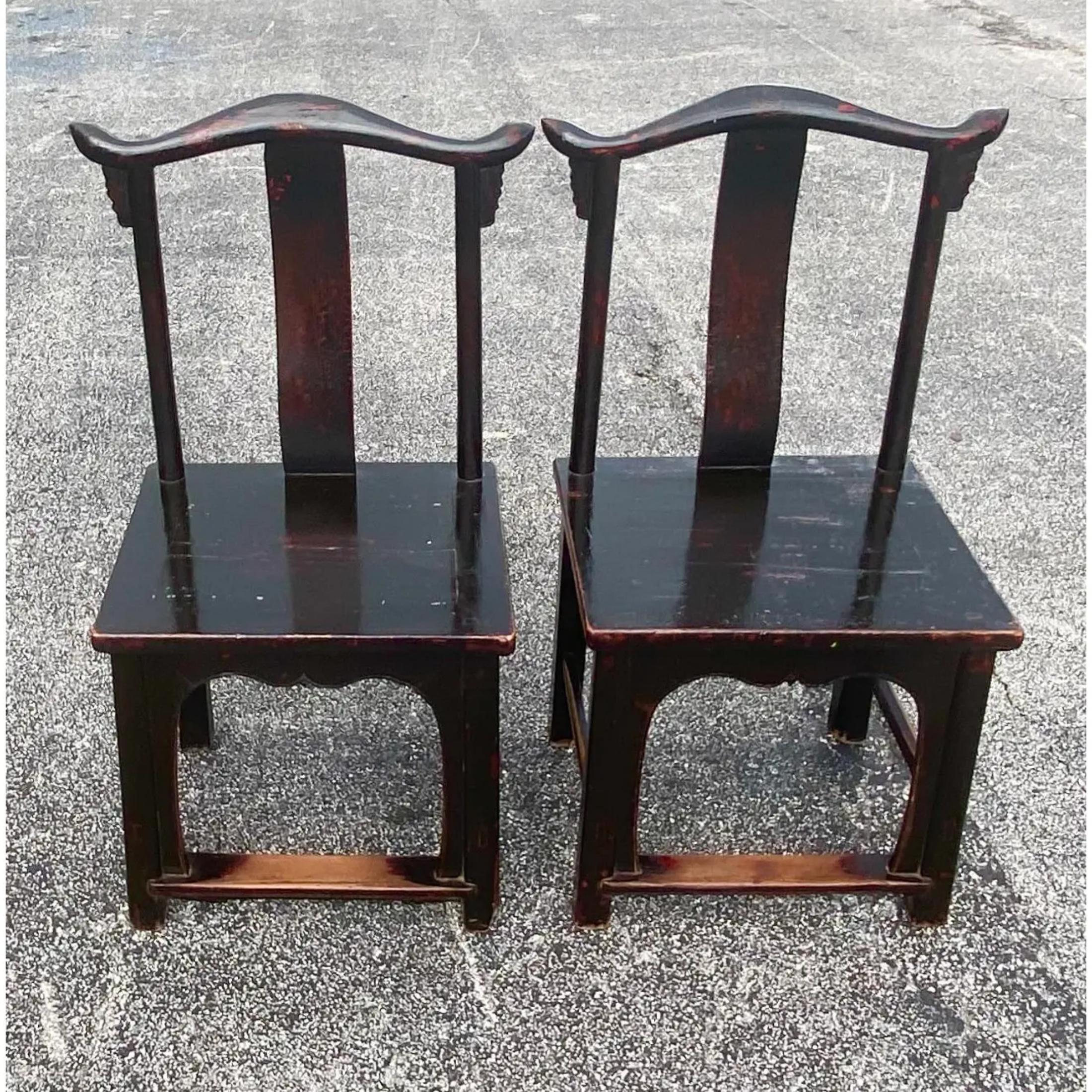 Fabulous pair of Asian emperor chairs. Dark brown with red undertones and a high holds finish. Acquired from a NY
