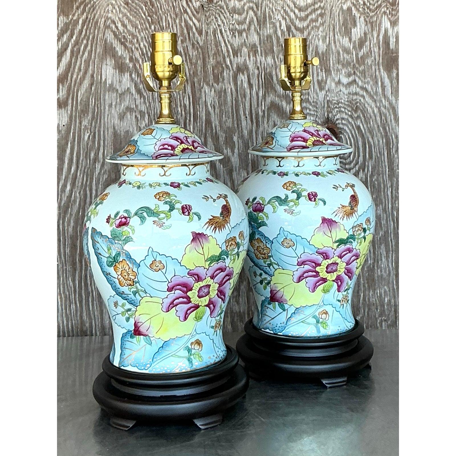 Add a touch of timeless elegance and worldly sophistication to your decor with this exquisite pair of vintage Asian ceramic table lamps. Each lamp features a gracefully shaped ginger jar body, complete with its original lid, all beautifully