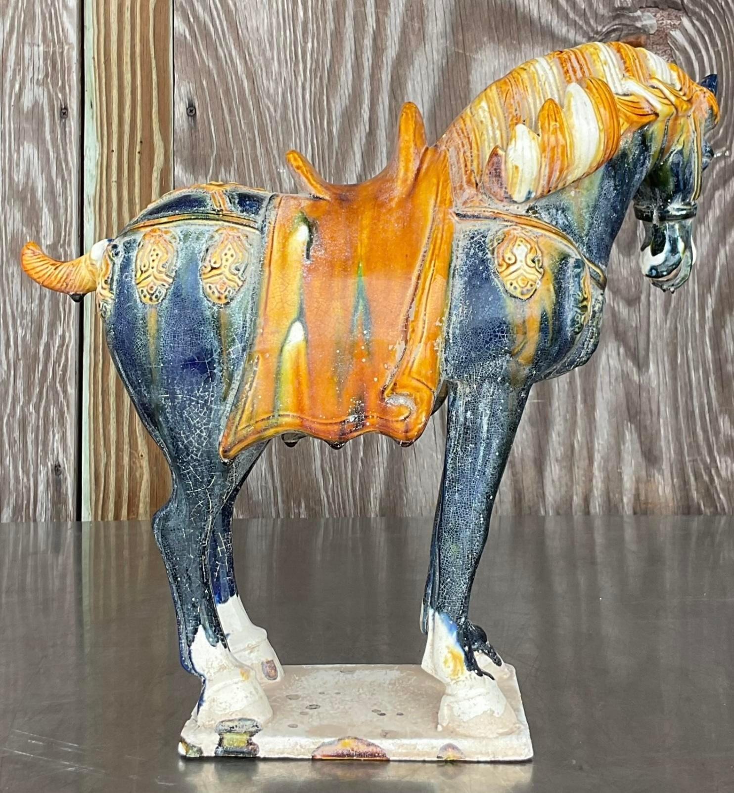 Elevate your decor with this Vintage Asian glazed ceramic Tang horse. Featuring exquisite craftsmanship and a rich glaze, this piece brings an elegant touch of Eastern artistry to your American home, perfect as a statement piece or a unique
