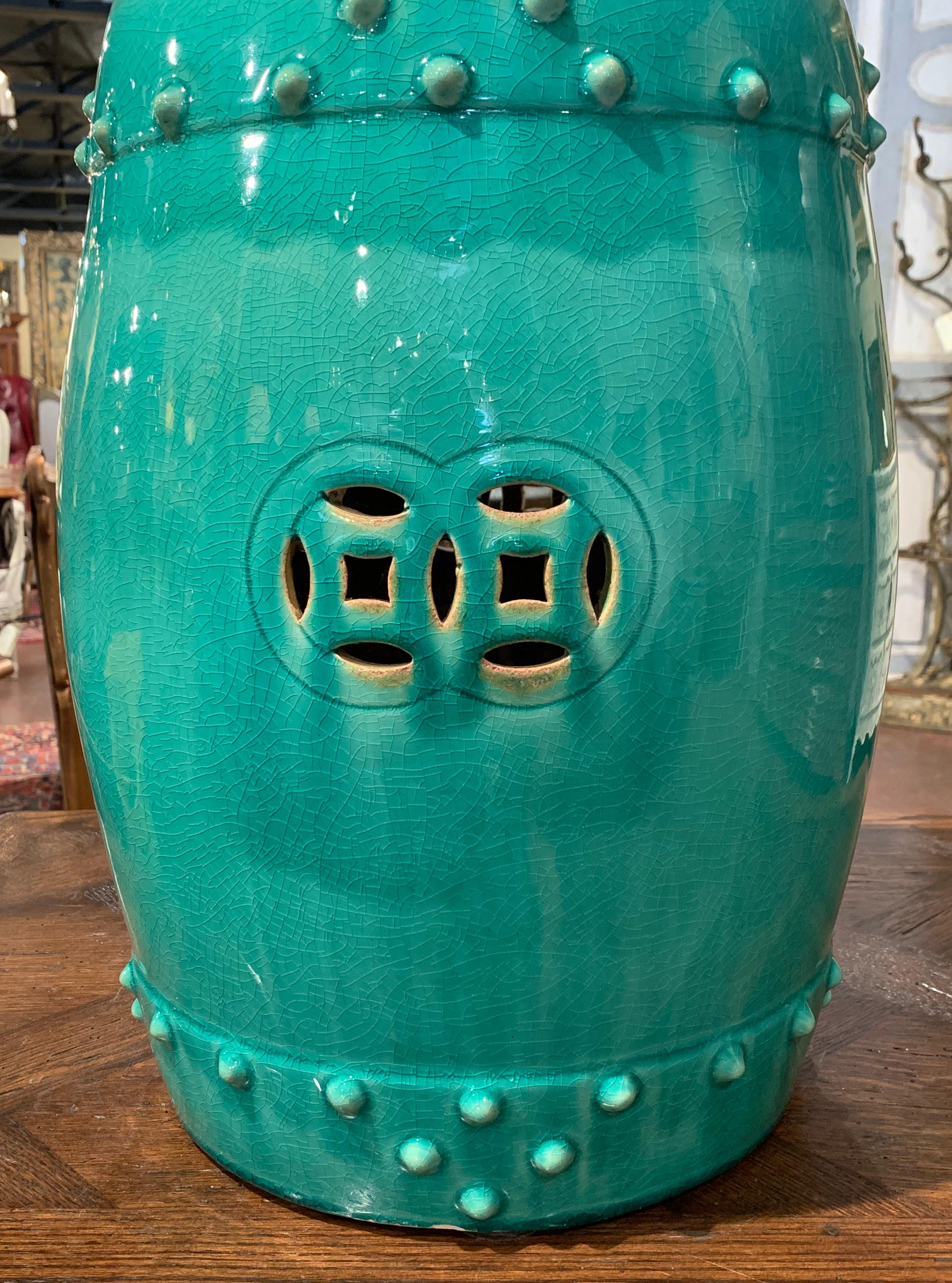 Decorate a den or a living room with this colorful vintage Celadon garden stool. Created in China, circa 1980 and round in shape, the porcelain seat is pierced on the top and around the perimeter for an intricate sculptural effect, and is further
