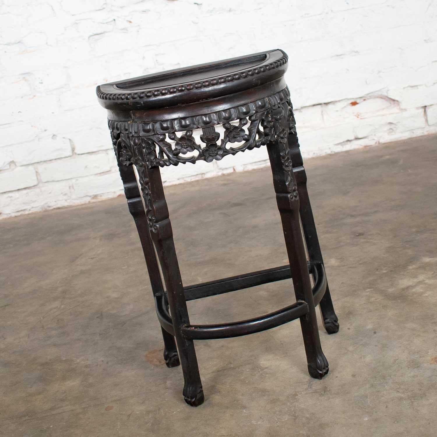 Gorgeous Asian half-moon console table, side table, demilune table or stand comprised of rich Asian hardwoods and a hand carved cherry blossom apron and pearl beading wood trim. It is in beautiful vintage condition with age appropriate cracks and