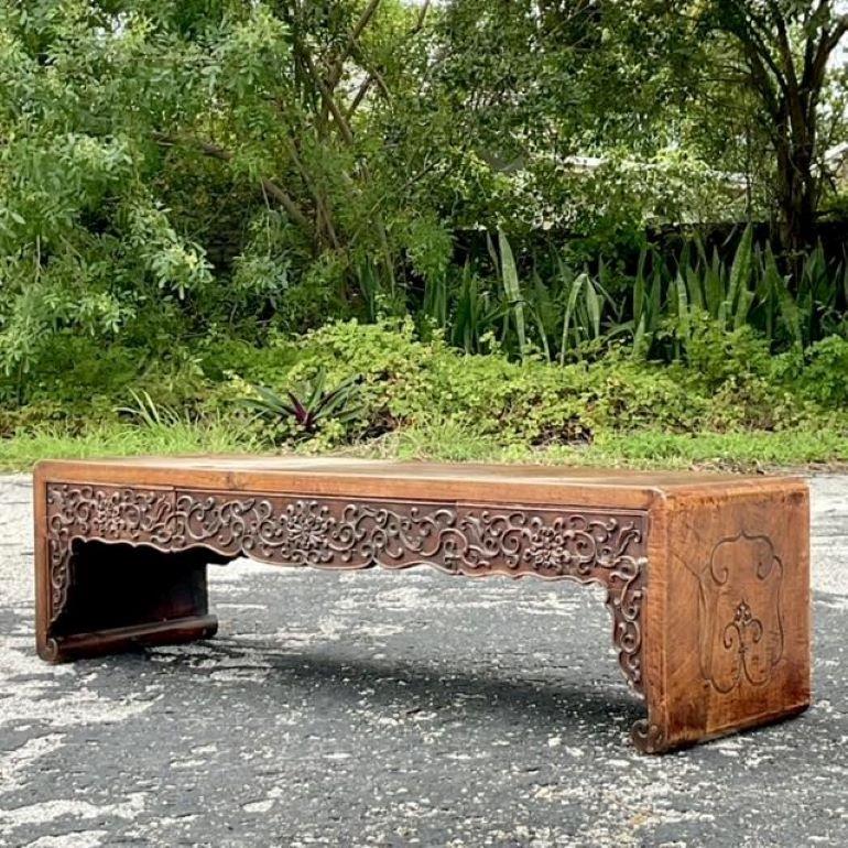 Introduce a touch of refined elegance to your space with this Vintage Asian Hand-Carved Low Altar Console Table. Meticulously crafted with intricate carvings along its edges and legs, this console table showcases the rich artistry and cultural