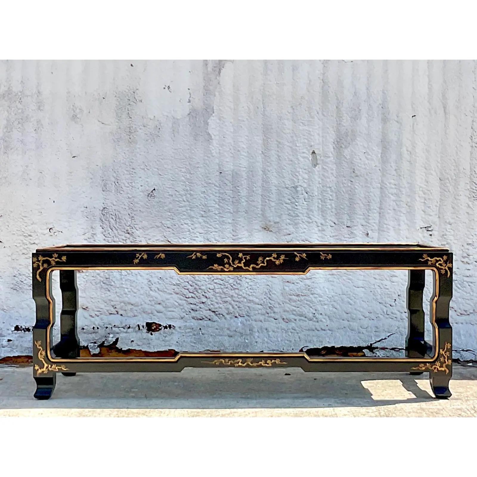 A fantastic vintage Asian Ming coffee table. A beautiful black lacquered forms with hand painted chinoiserie detail. Acquired from a Palm Beach estate.
