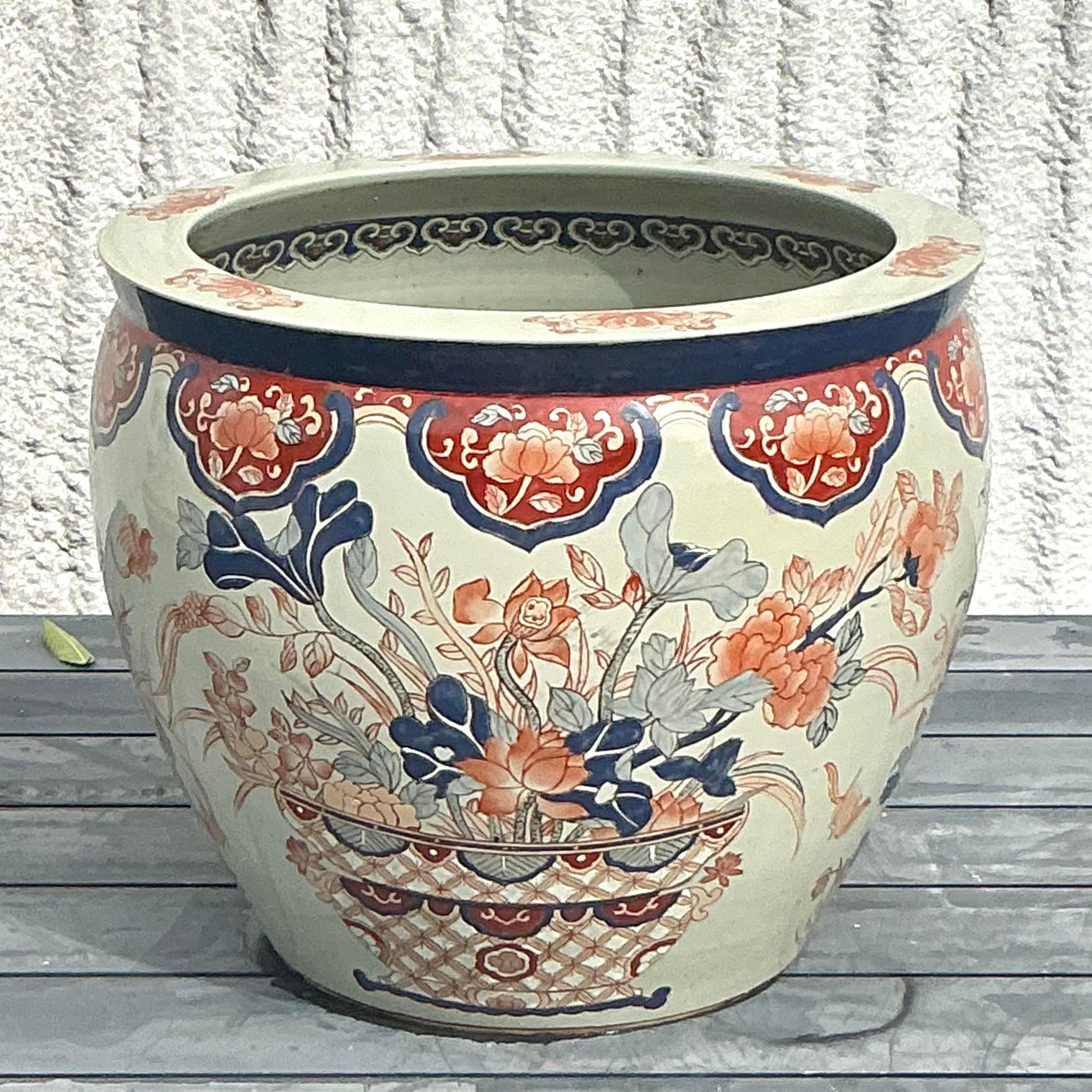 Elevate your décor with the exquisite craftsmanship of this Vintage Asian Imari Planter. Showcasing the traditional Imari style, this planter features intricate hand-painted designs with vibrant hues of cobalt blue, deep reds, and touches of gold.