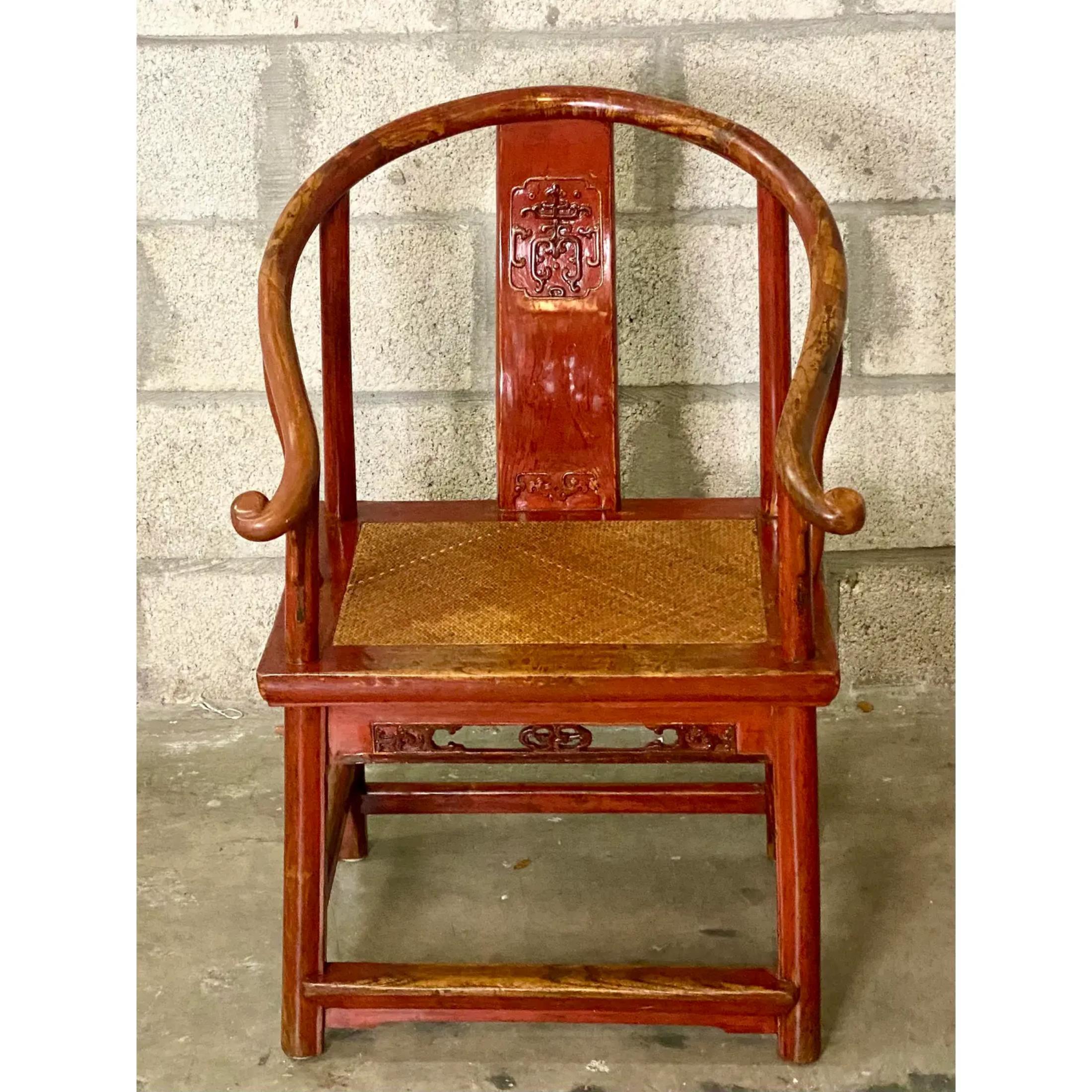 Stunning vintage Asian lacquered chair. A tradition chair reserved for the bride. It’s advanced age has given it a beautiful patina and sheen. Woven rattan seat. Acquired from a Delray estate