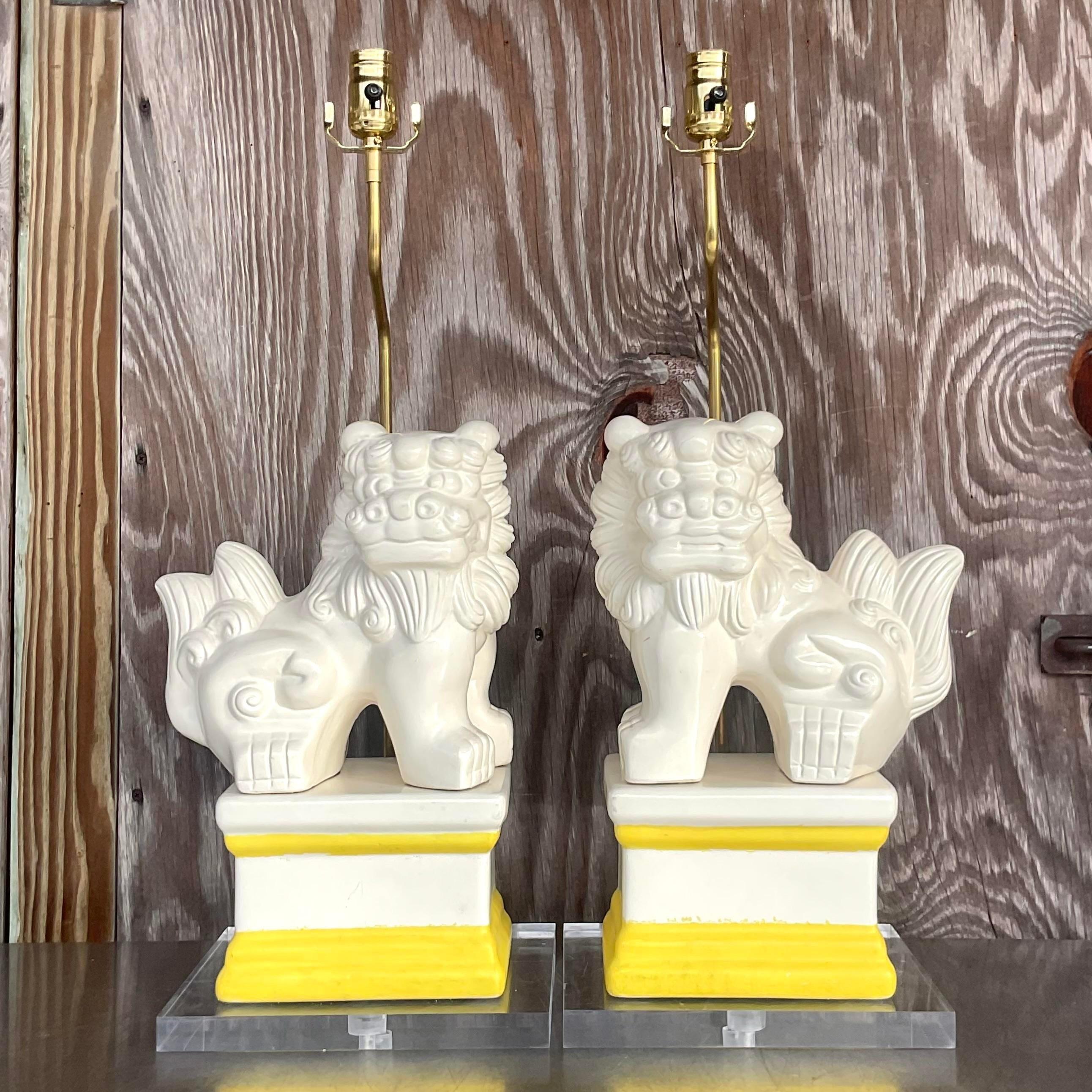 A fabulous pair of vintage Asian table lamps. A chic lacquered foo dog on a stacked lucite pedestal. Fully restored with all new wiring and hardware. Acquired from a Palm Beach estate. 