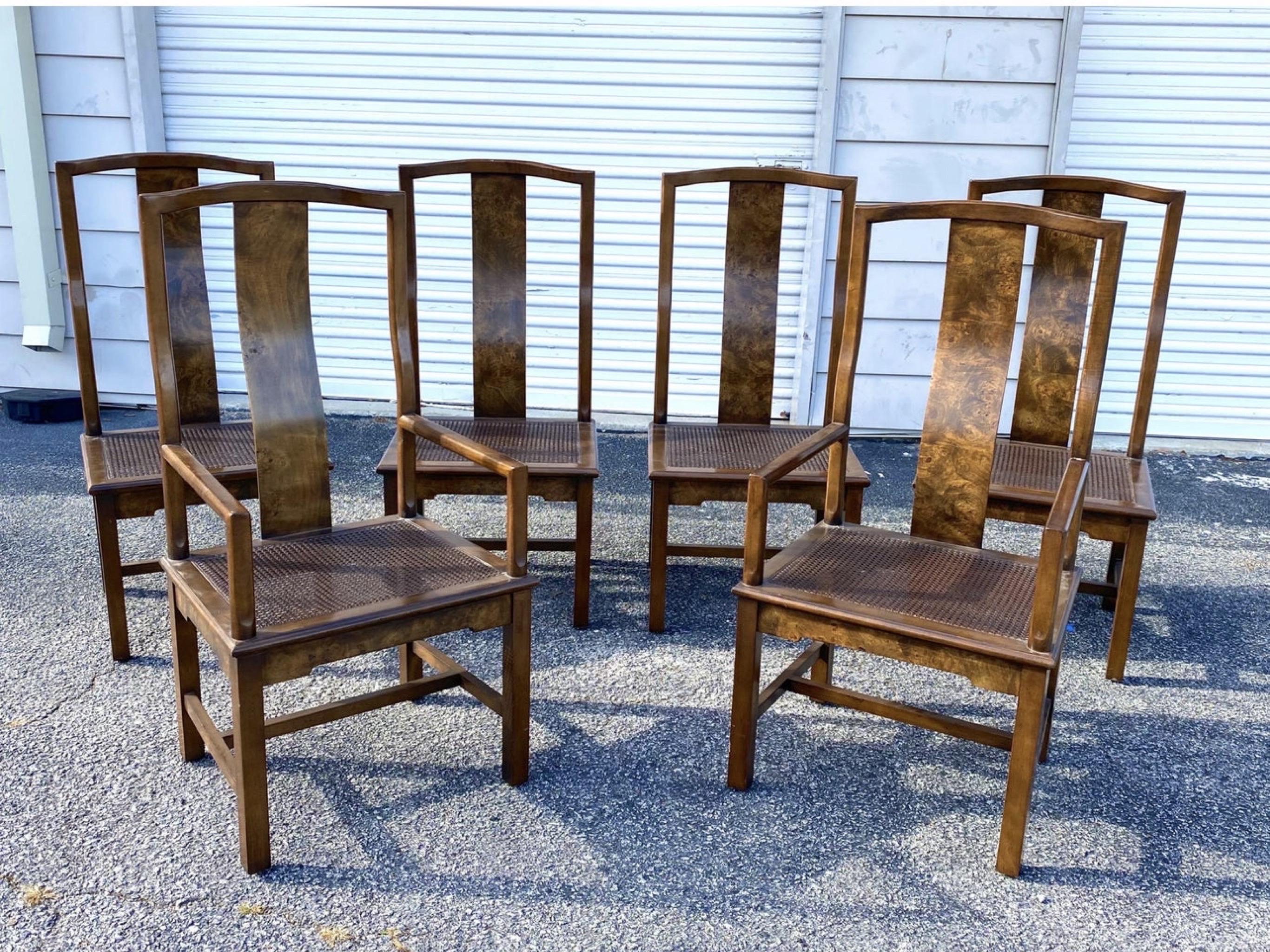 This absolutely stunning set of 6 Asian modern yolk style dining chairs have sexy curved backs with a burl finish and a burl apron adorning all the chair’s seats. Cane seats are all in very good condition with no breaks in the cane. The frames are