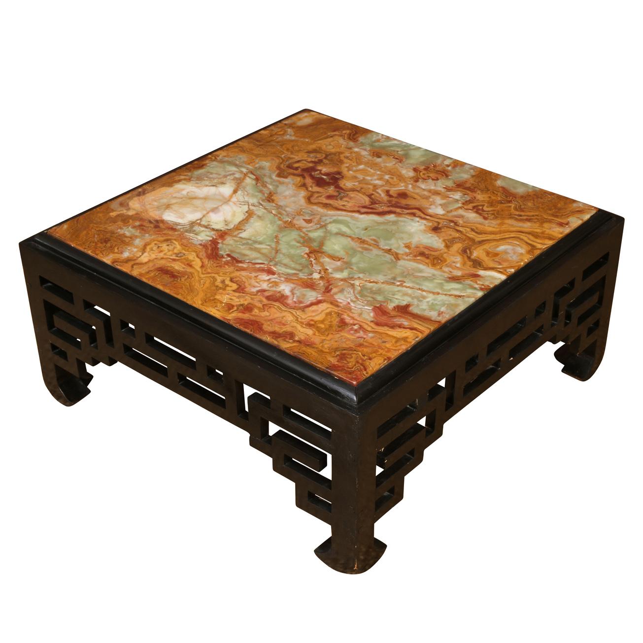 A vintage Asian square coffee table with a black lacquer fretwork base and a multicolored onyx stone top.