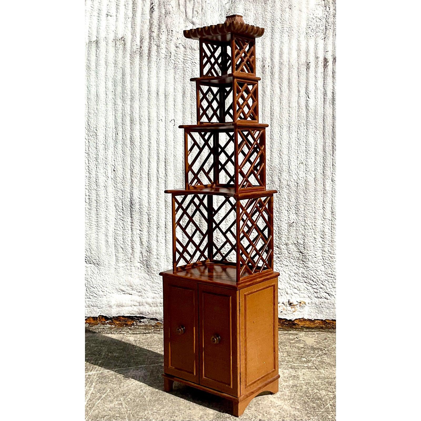 Fantastic vintage Asian carved pagoda etagere. Beautiful ascending shelving with a chic Chinese Chippendale design. Double doors below reveal nice storage. Acquired from a Palm Beach estate.