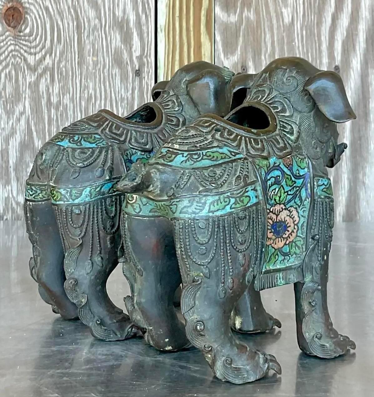 Elevate your décor with a touch of exotic elegance and American sophistication. This pair of vintage Asian patinated Foo Dogs exudes timeless charm, blending Eastern mystique with Western refinement, making them a captivating statement piece for any