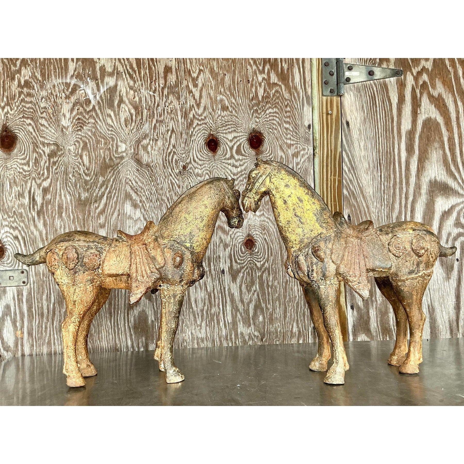 These stunning vintage Asian temple horses bring a touch of mysticism and ancient elegance to any interior. Cast in wood and beautifully patinated with golden and bronze hues, this pair of horses exudes a sense of history and craftsmanship. Their